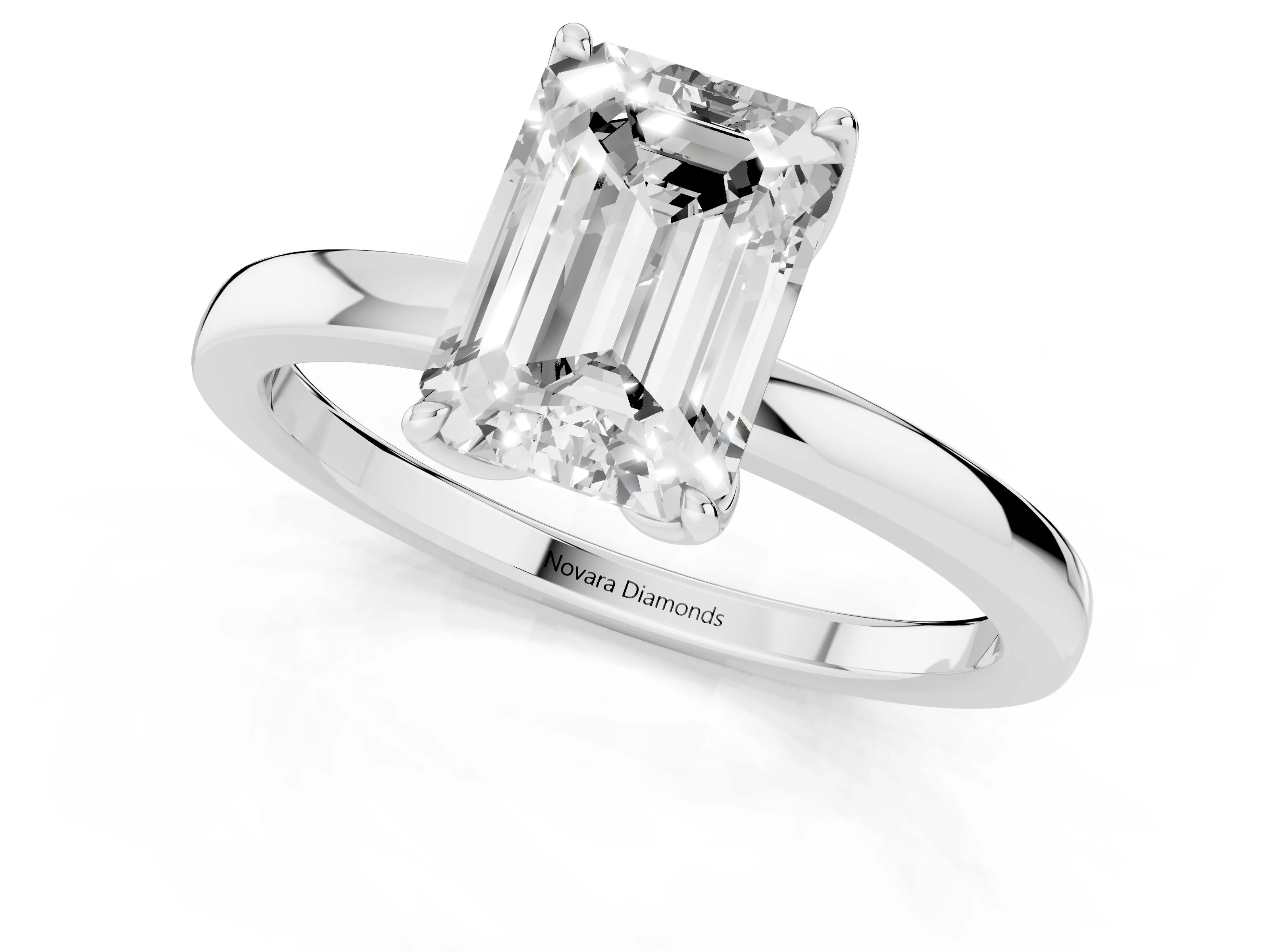 Emerald Cut Diamond Solitaire Ring Set in White gold with Prong Setting and Thin Polished Band