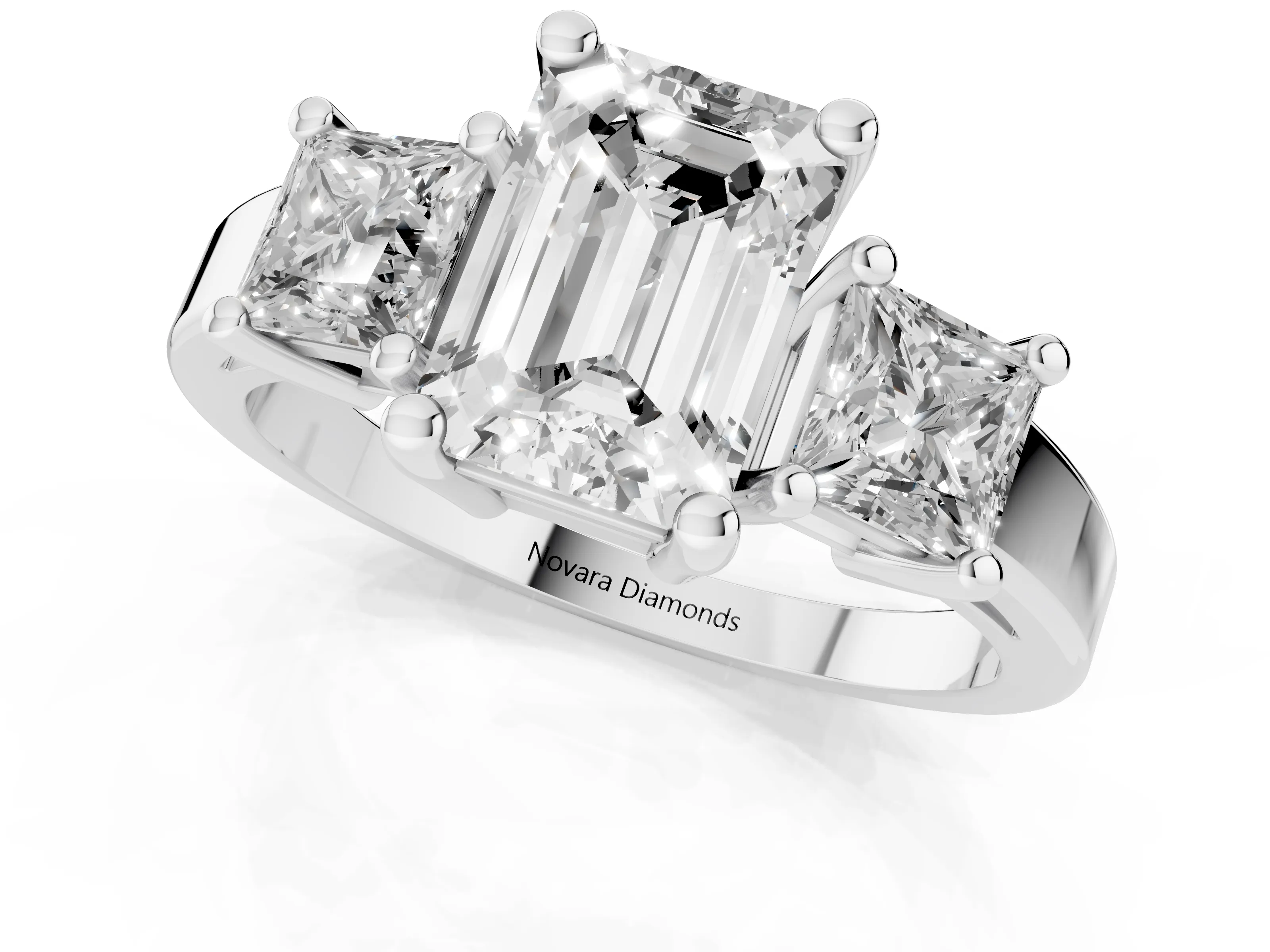 Three-Stone Emerald Cut Diamond Solitaire Ring Set in Platinum with Prong Setting