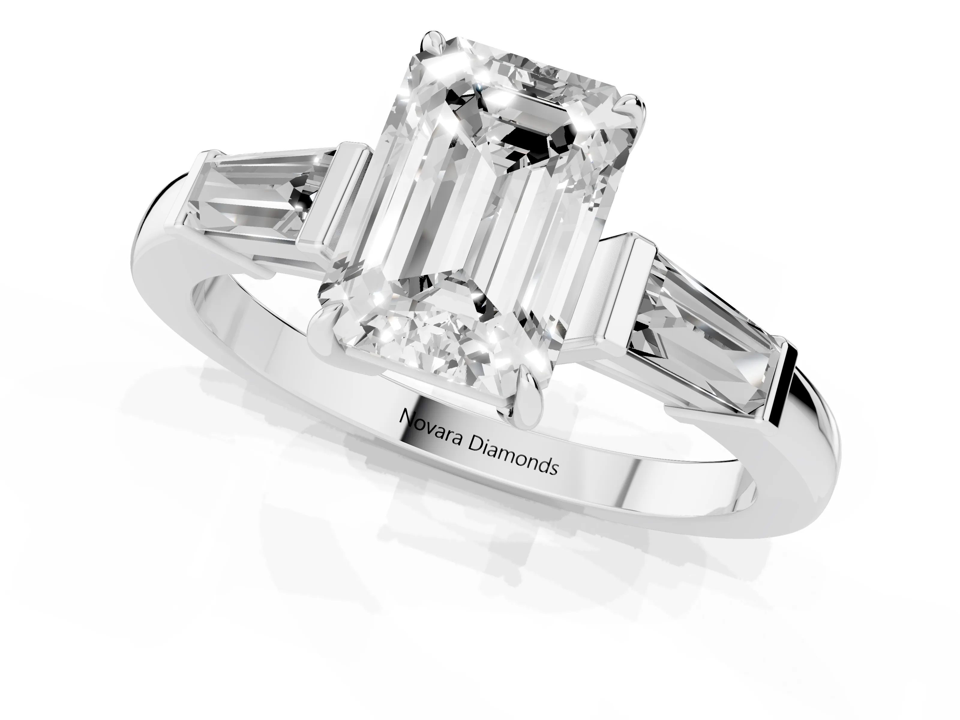 Emerald Cut Diamond Three-Stone Ring Set in Platinum with Tapered Baguette Side Stones and Prong Setting