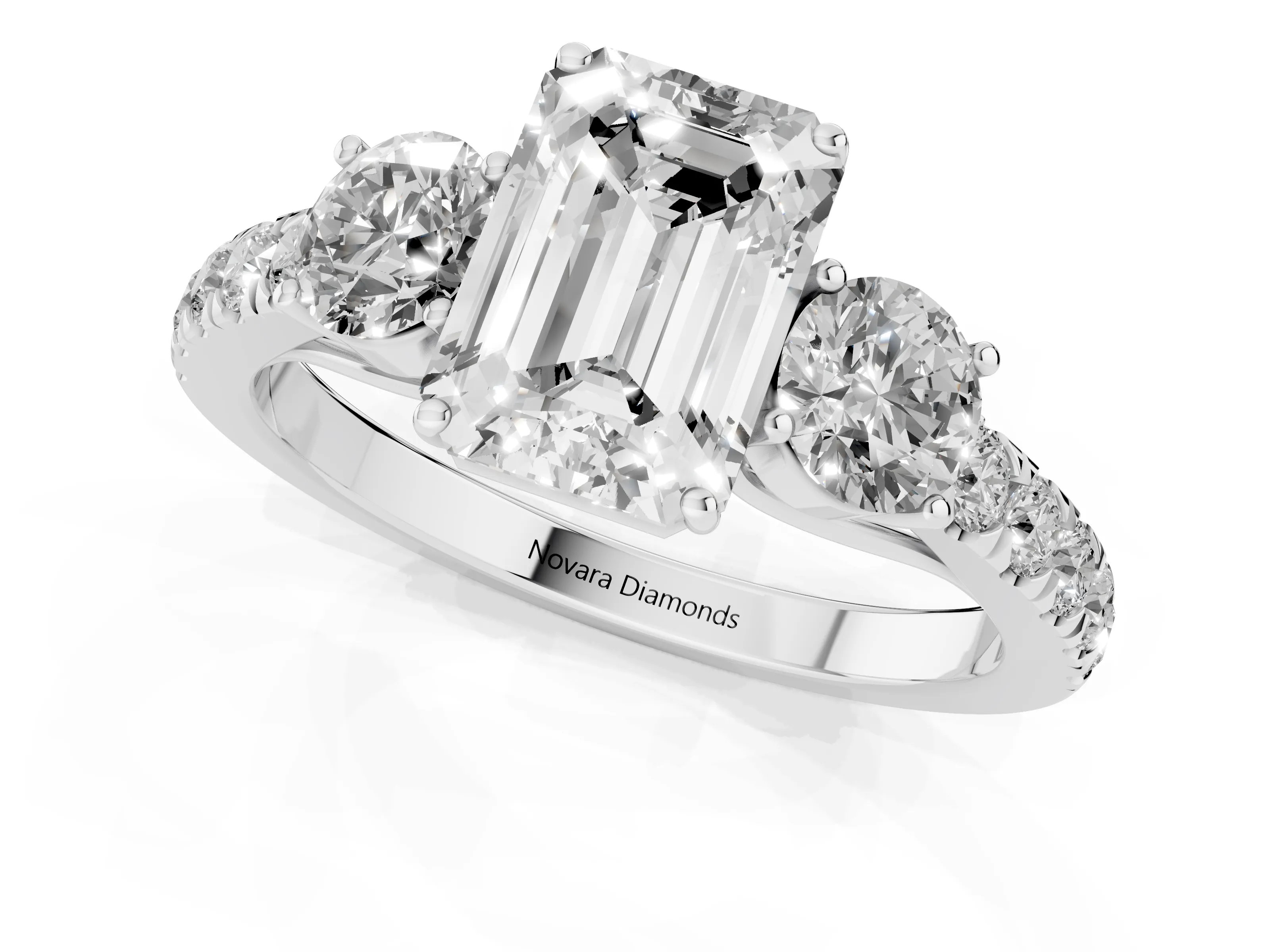Emerald Cut Diamond Three-Stone Ring Set in White gold with Round Side Stones and Delicate Pavé Band
