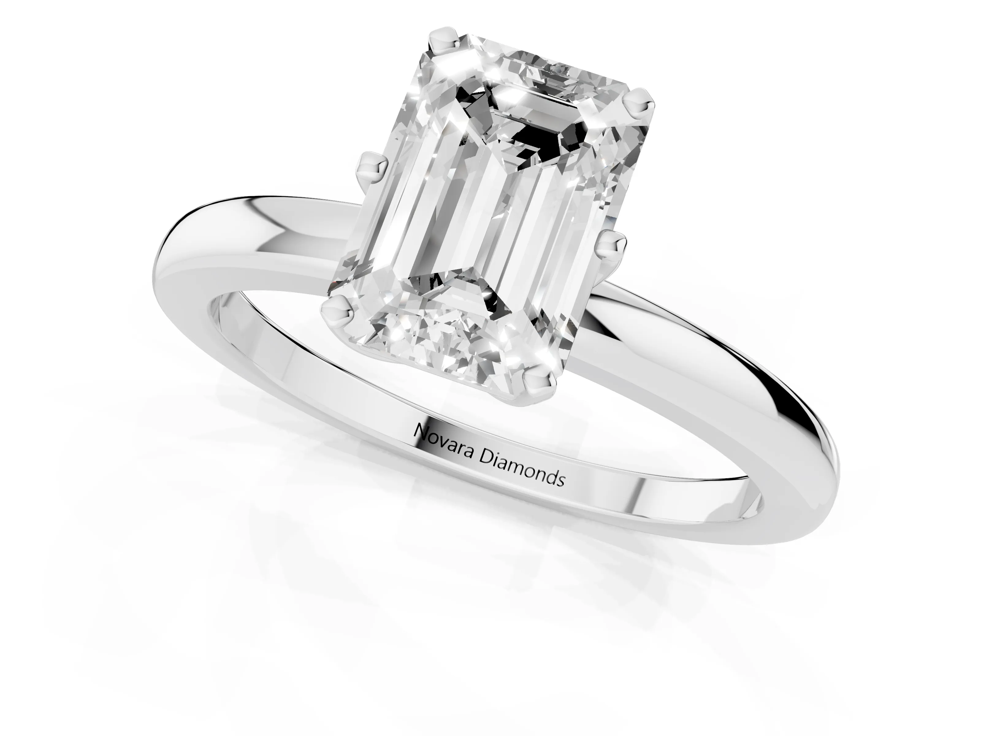 Emerald Cut Diamond Solitaire Ring Set in White gold with Raised Prong Setting on a Classic Band