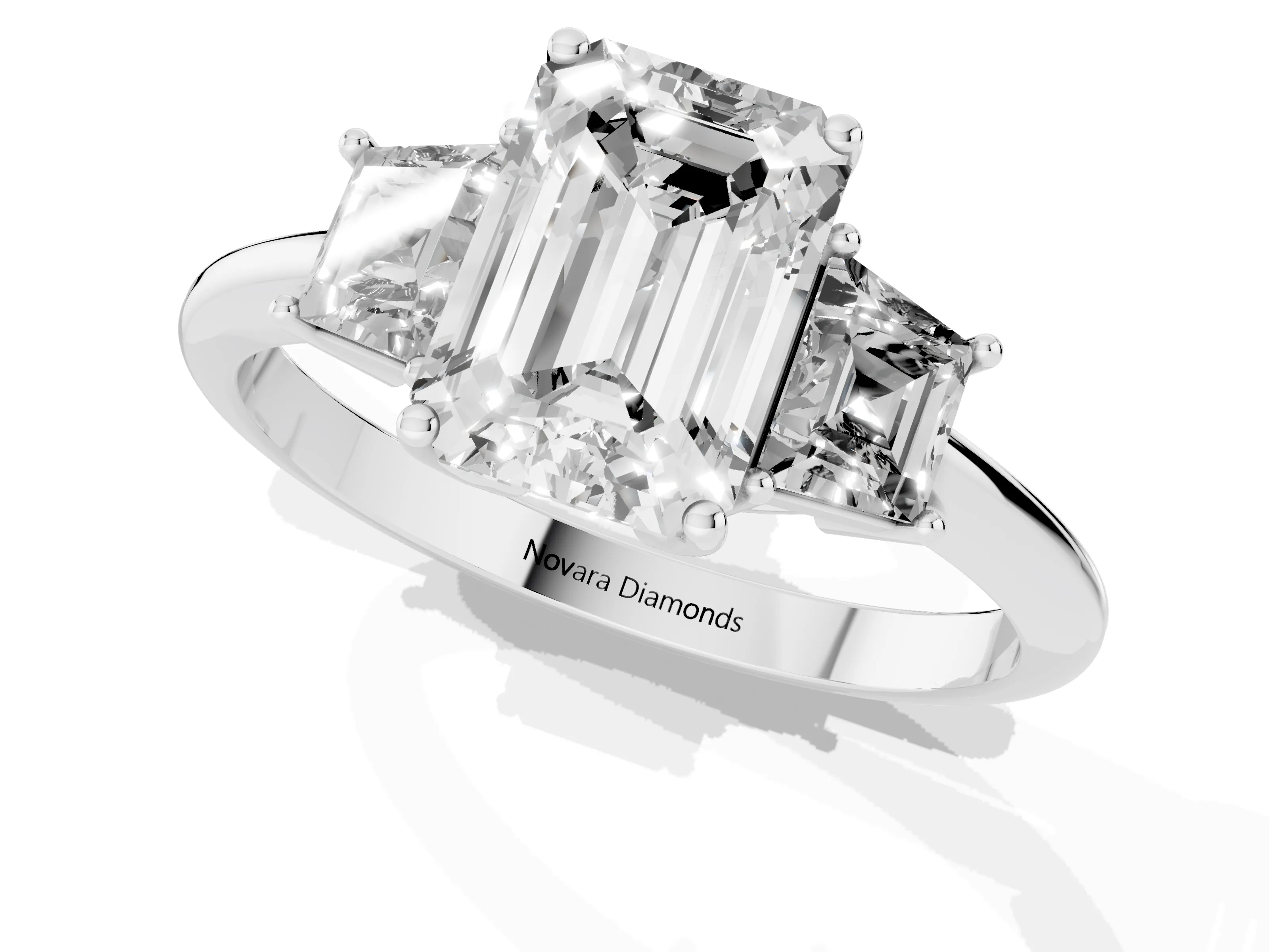 Emerald Cut Diamond Three-Stone Ring Set in Platinum with Trapezoid Side Stones and Prong Setting
