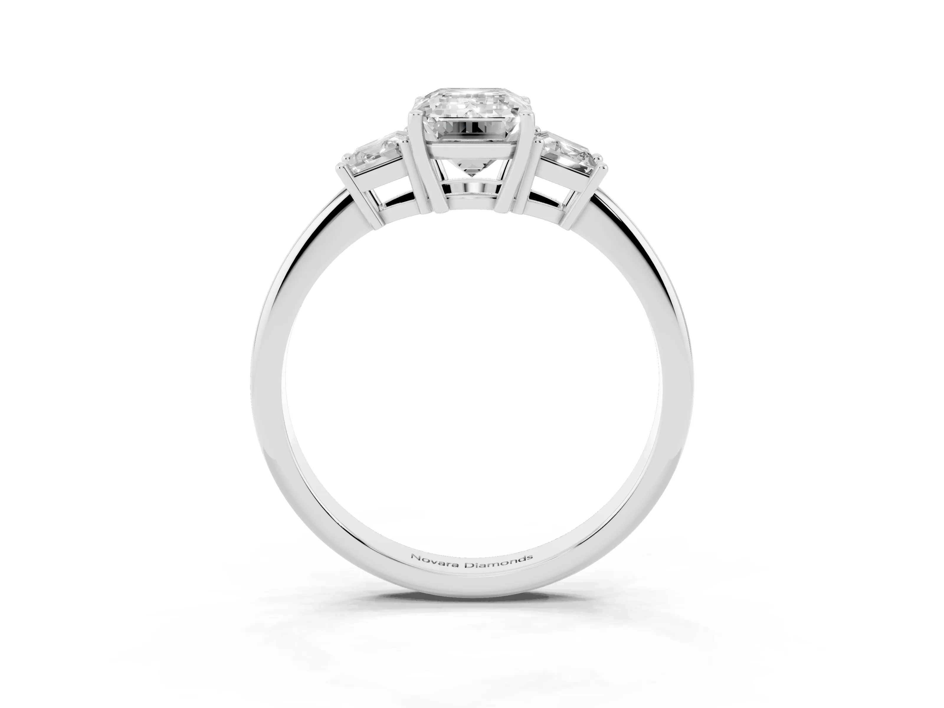 Emerald Cut Diamond Three-Stone Ring Set in Platinum with Trapezoid Side Stones and Prong Setting