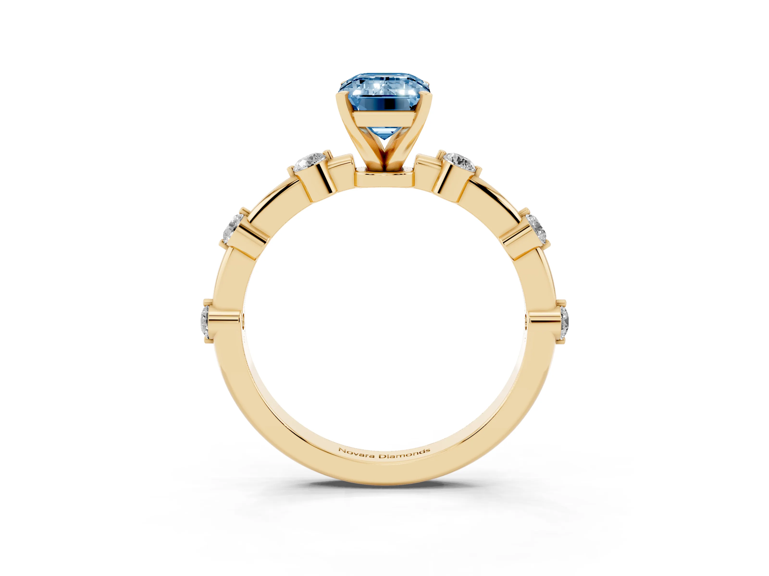 Fancy Blue Emerald Cut Diamond Solitaire Ring Set in Yellow gold with Bezel Set Side Stones and Prong Setting