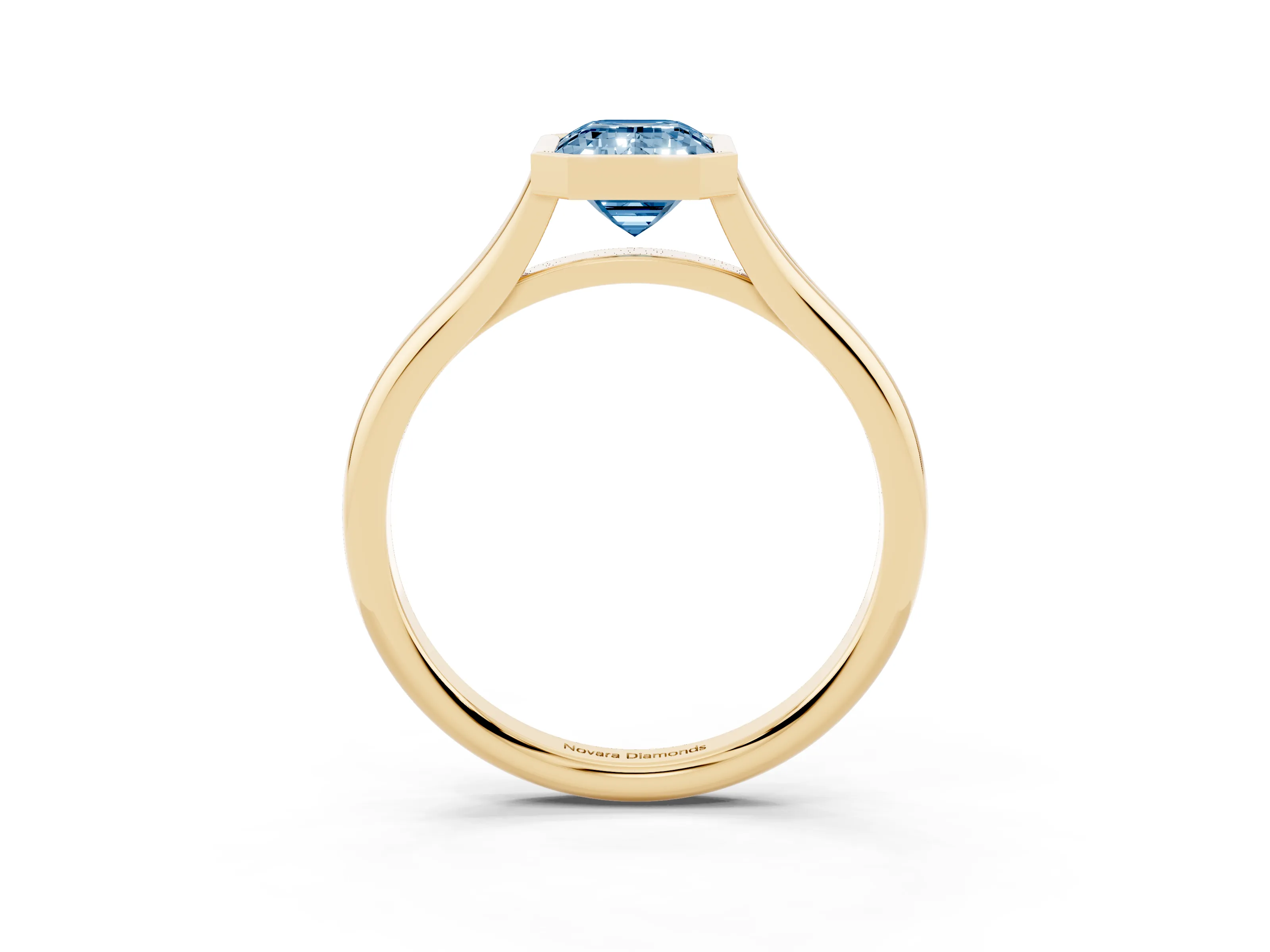 Fancy Blue Bezel Set Emerald Cut Diamond Solitaire Ring Set in Yellow gold with Tapered Band