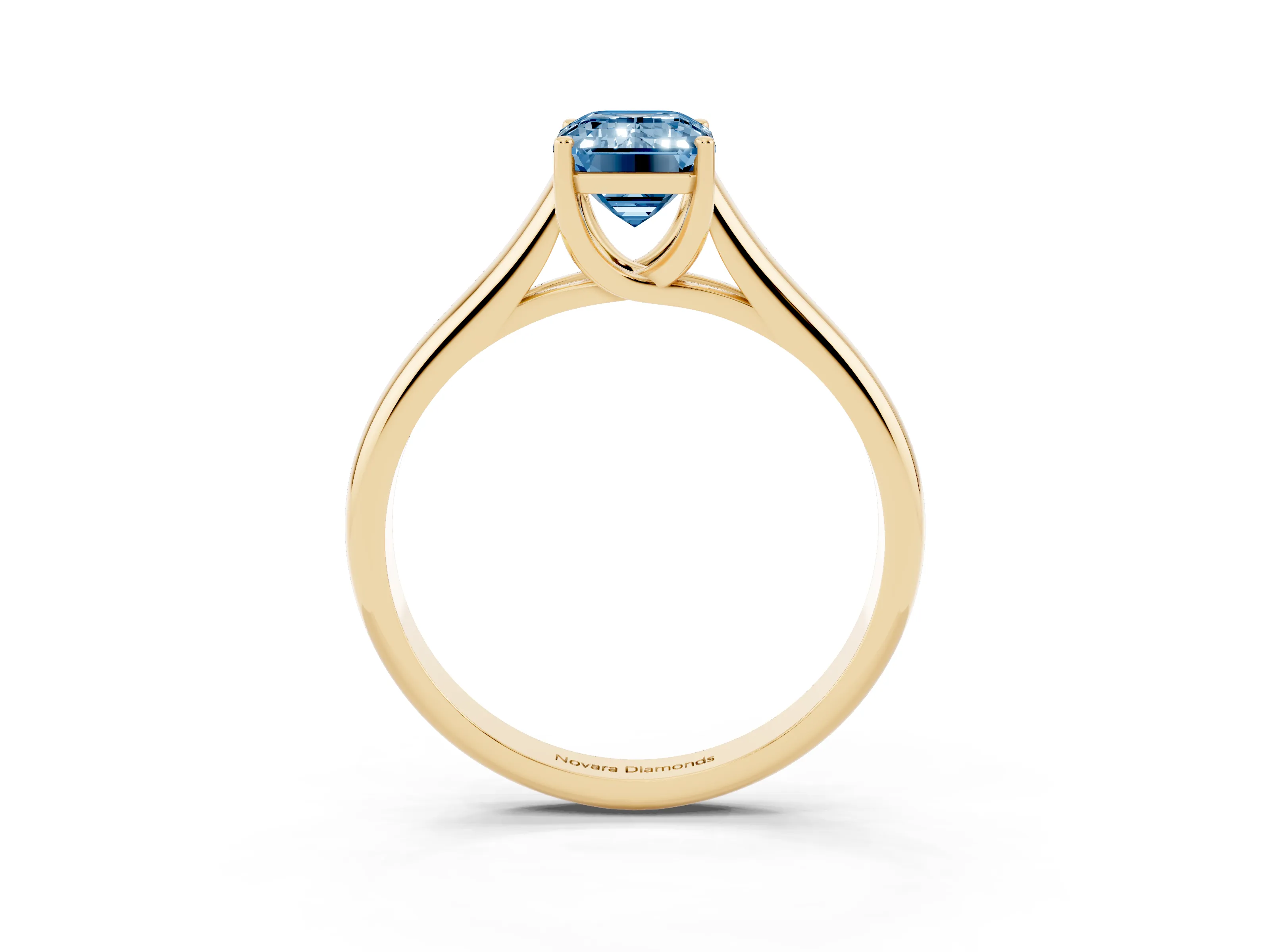 Fancy Blue Emerald Cut Diamond Solitaire Engagement Ring Set in Yellow gold with Subtly Tapered Band and Prong Setting