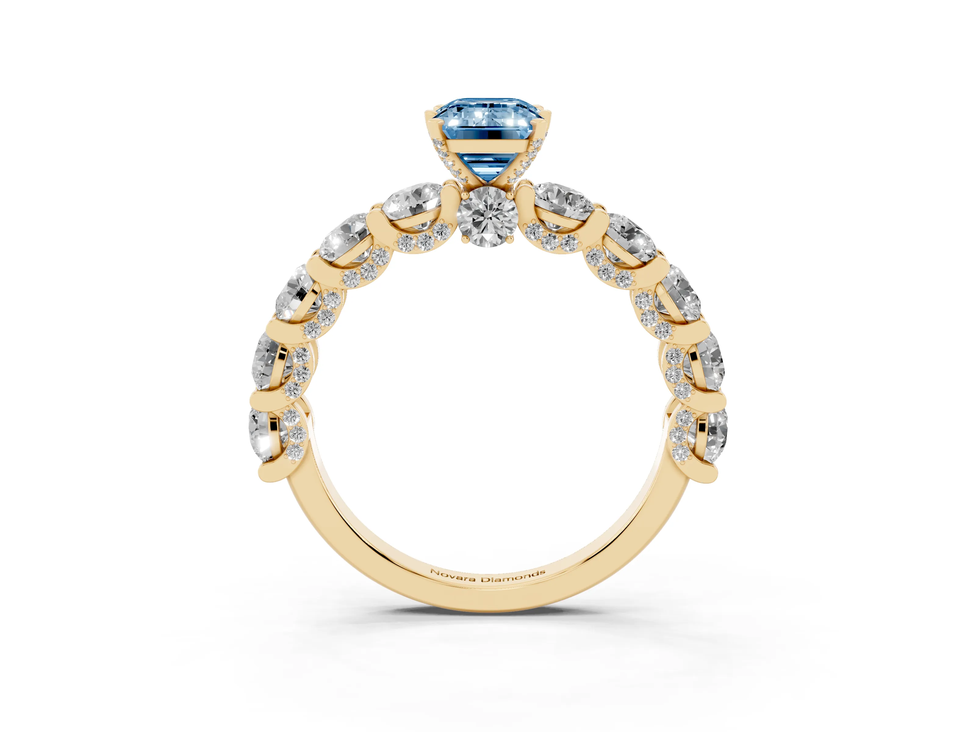 Fancy Blue Emerald Cut Diamond Side Stone Ring Set in Yellow gold with Alternating Round and Oval Side Stones