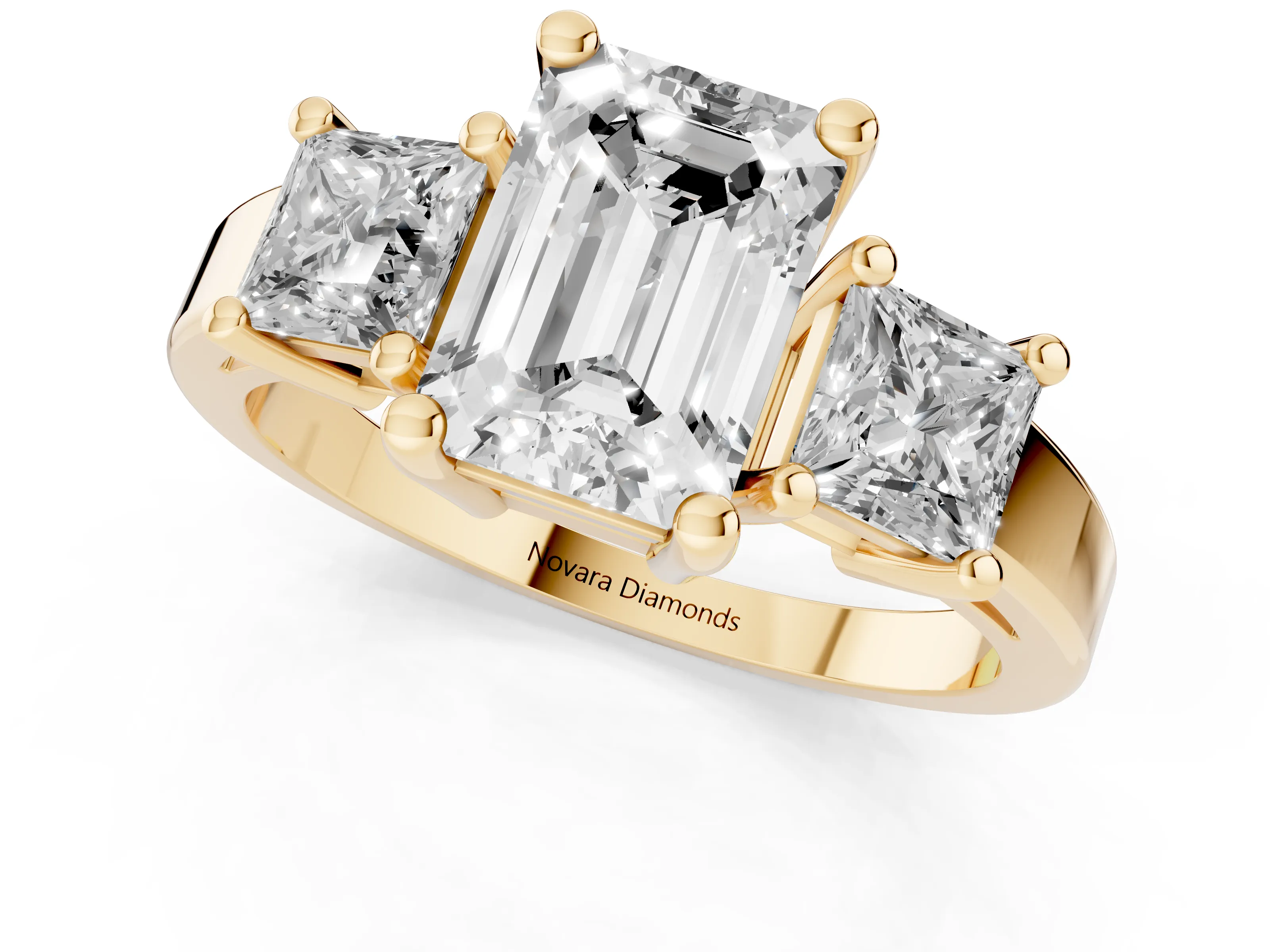 Three-Stone Emerald Cut Diamond Solitaire Ring Set in Yellow gold with Prong Setting