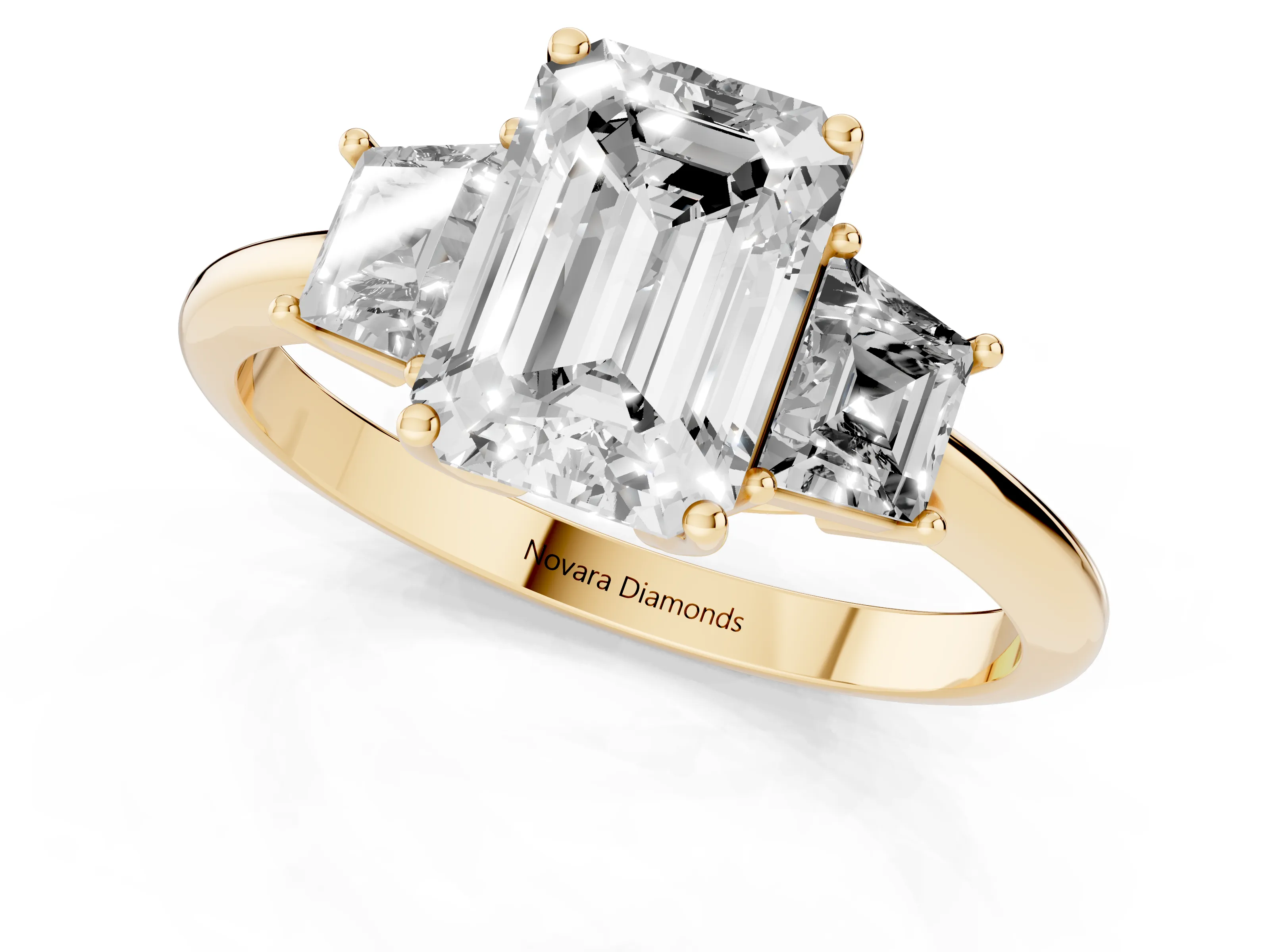 Emerald Cut Diamond Three-Stone Ring Set in Yellow gold with Trapezoid Side Stones and Prong Setting
