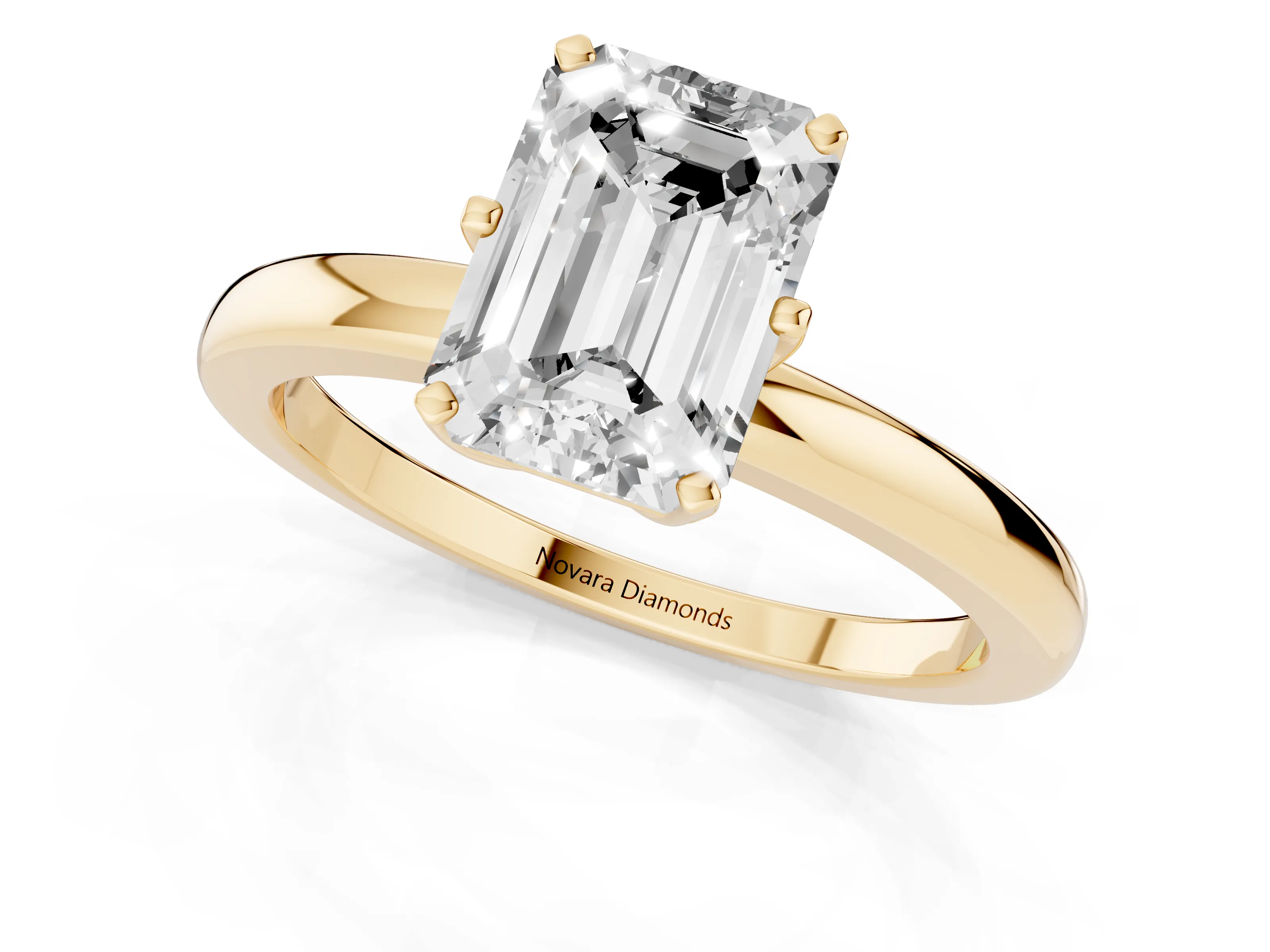 Emerald Cut Diamond Solitaire Ring Set in Yellow gold with Raised Prong Setting on a Classic Band
