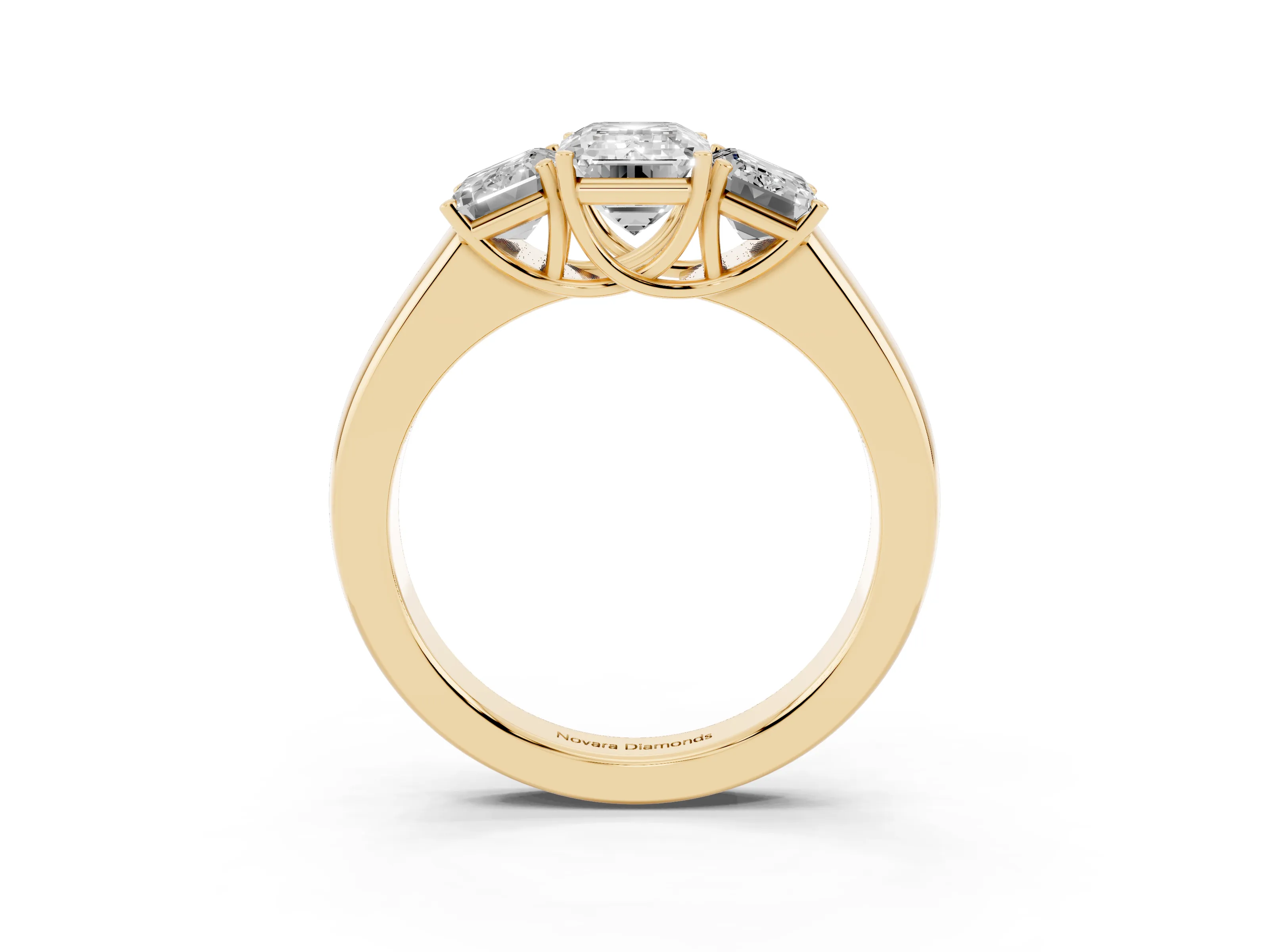 Three-Stone Emerald Cut Diamond Ring Set in Yellow gold with Matching Prong Settings and Plain Band