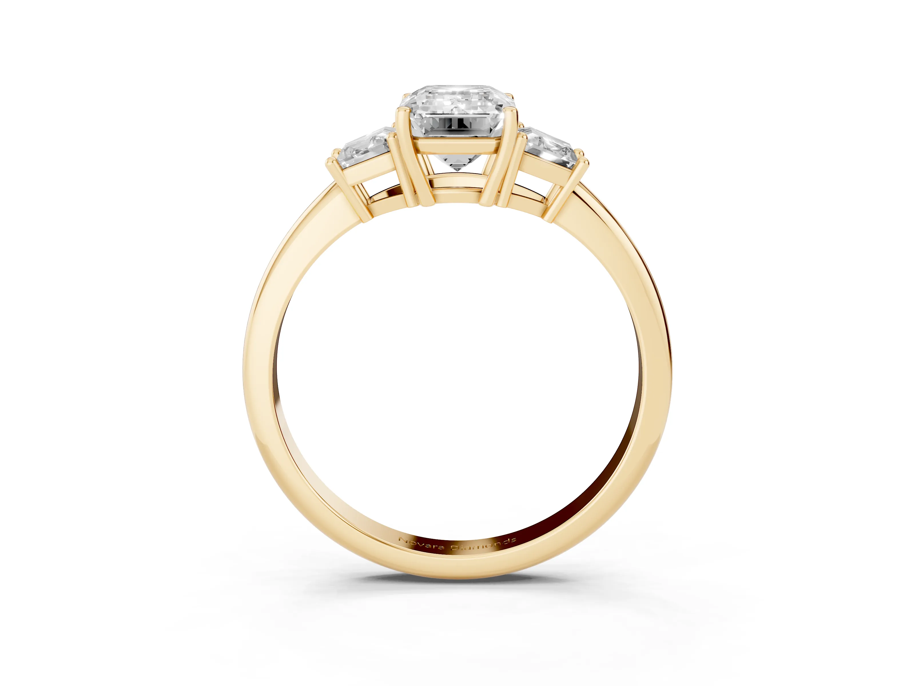 Emerald Cut Diamond Three-Stone Ring Set in Yellow gold with Trapezoid Side Stones and Prong Setting