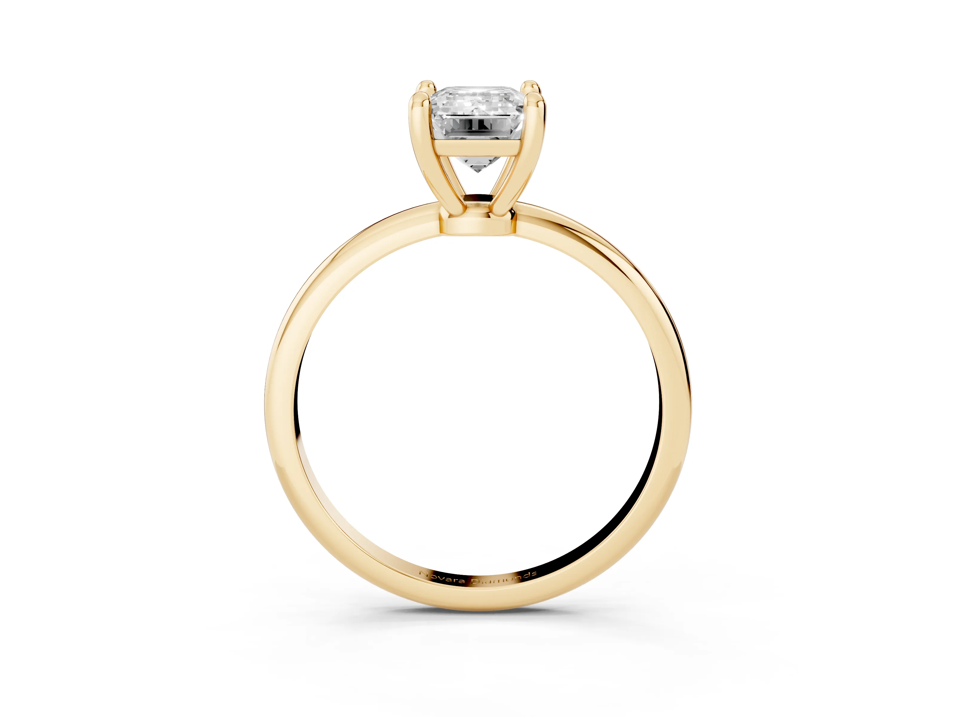 Emerald Cut Diamond Solitaire Ring Set in Yellow gold with Secure Prong Setting on a Classic Band
