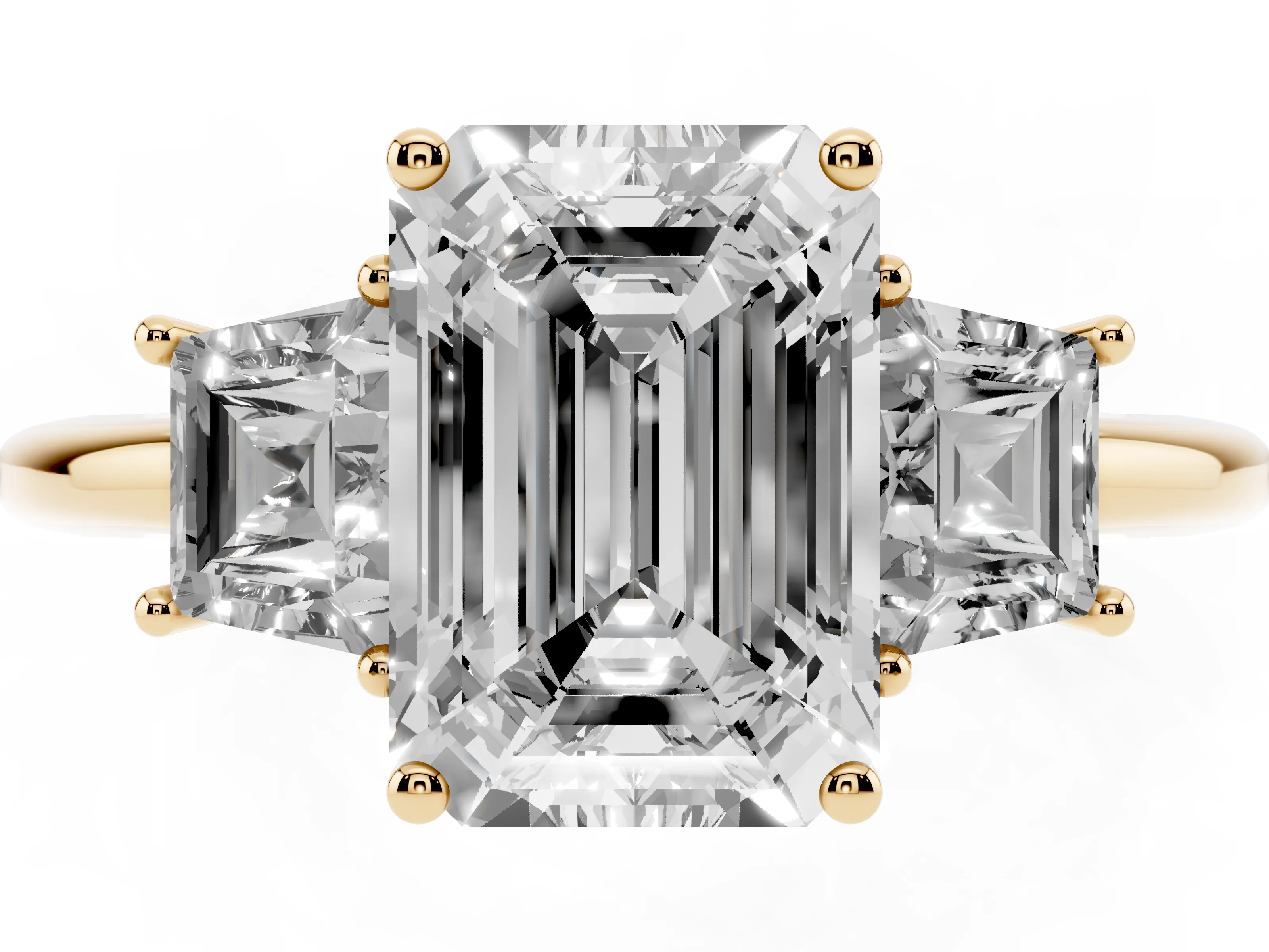 Emerald Cut Diamond Three-Stone Ring Set in Yellow gold with Trapezoid Side Stones and Prong Setting