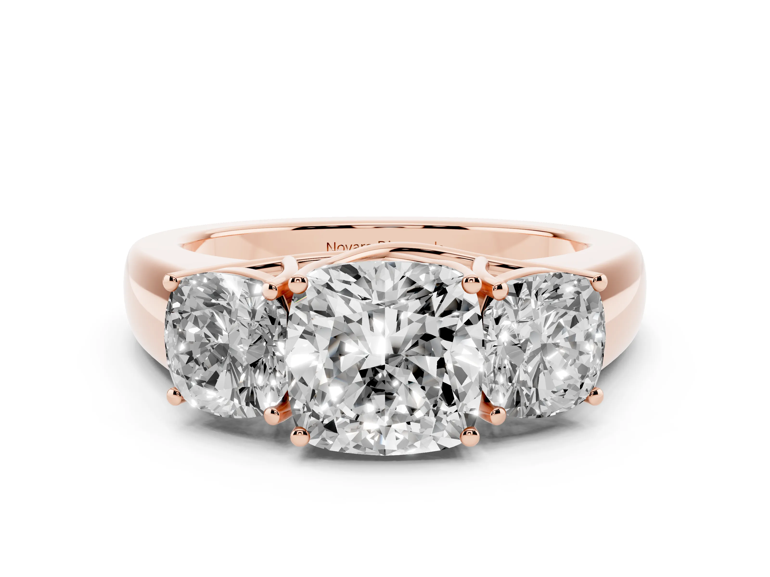 Three-Stone Cushion Cut Diamond Ring Set in Rose gold with Matching Prong Settings and Plain Band