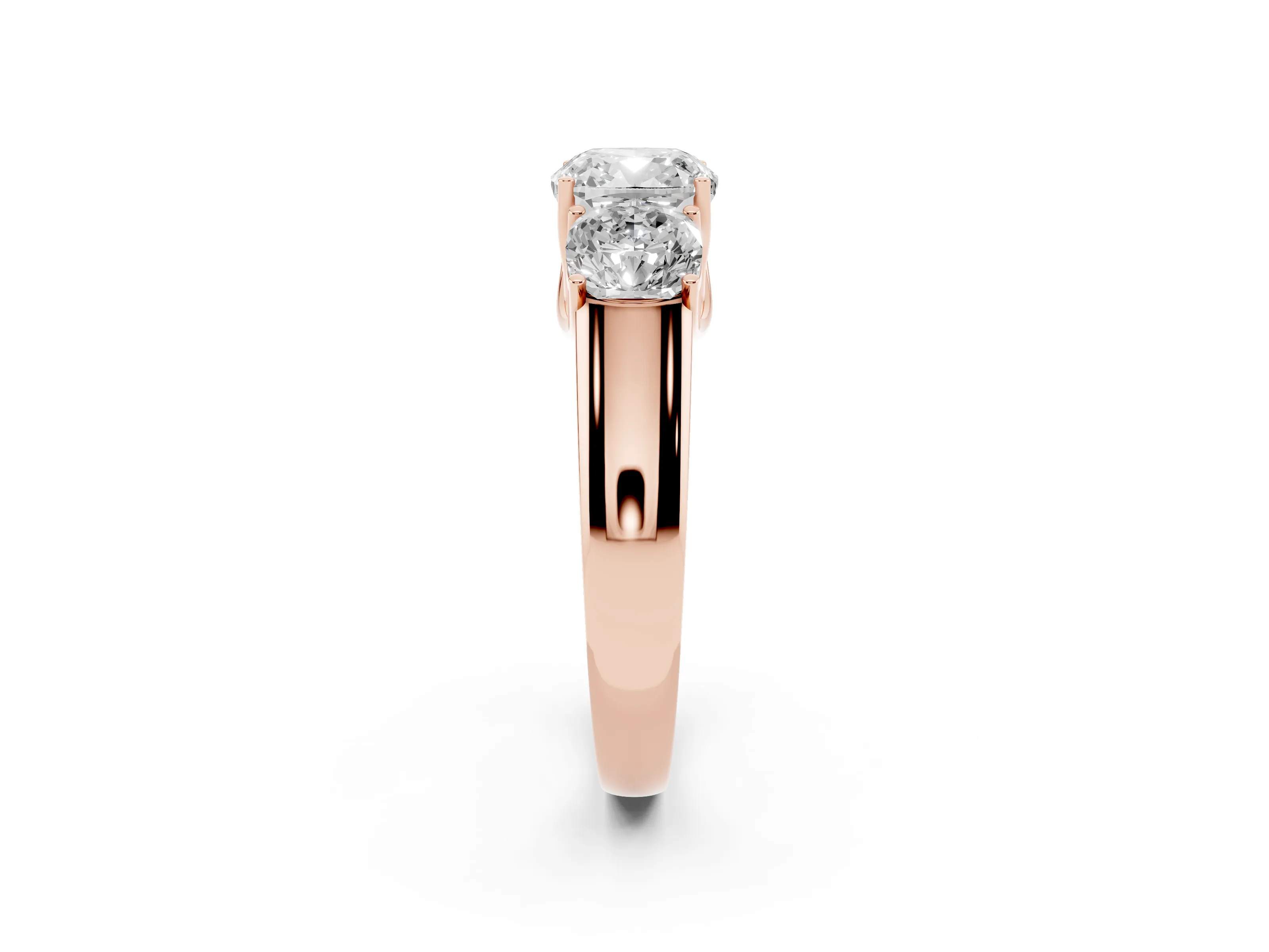 Three-Stone Cushion Cut Diamond Ring Set in Rose gold with Matching Prong Settings and Plain Band