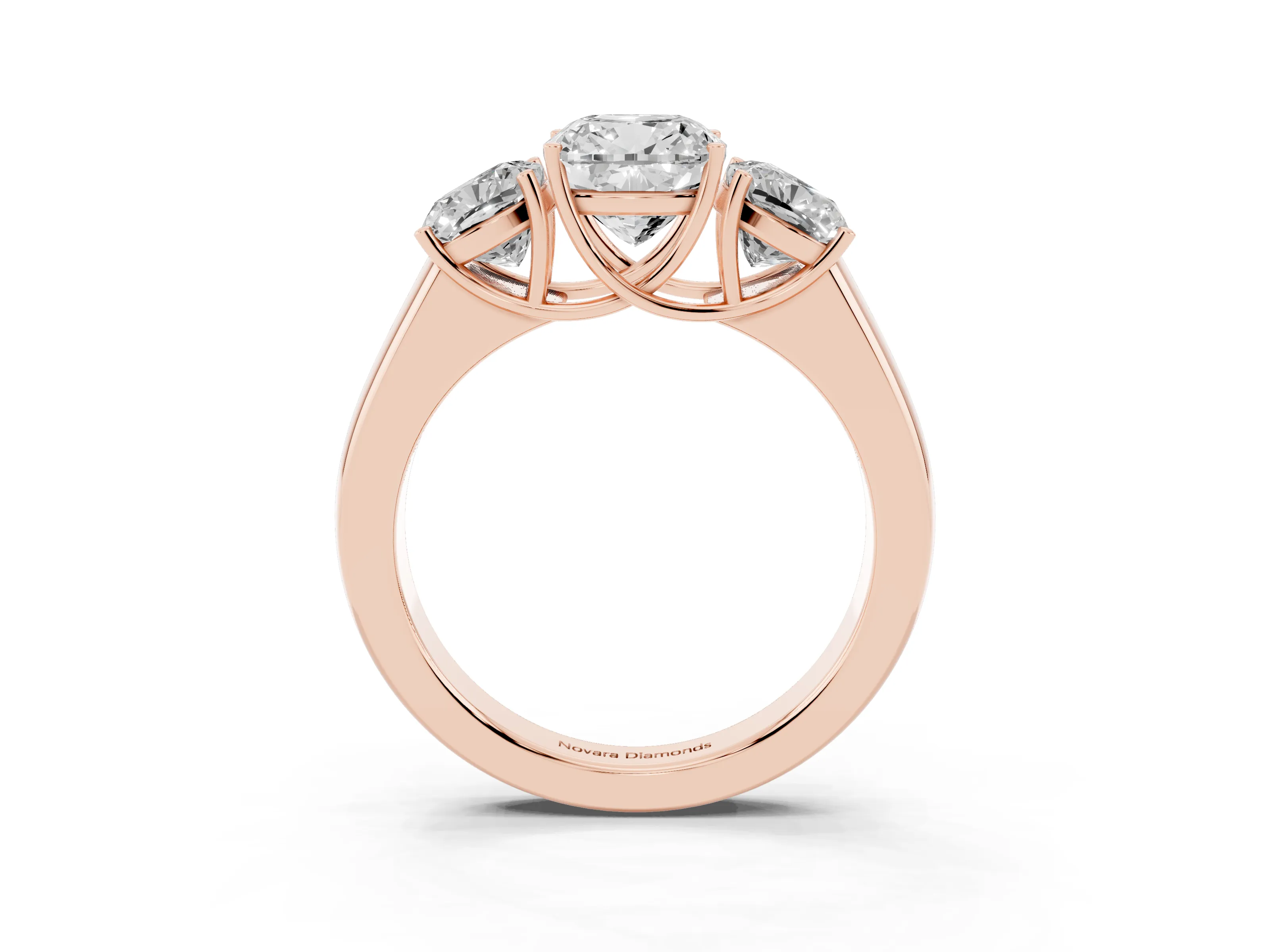 Three-Stone Cushion Cut Diamond Ring Set in Rose gold with Matching Prong Settings and Plain Band