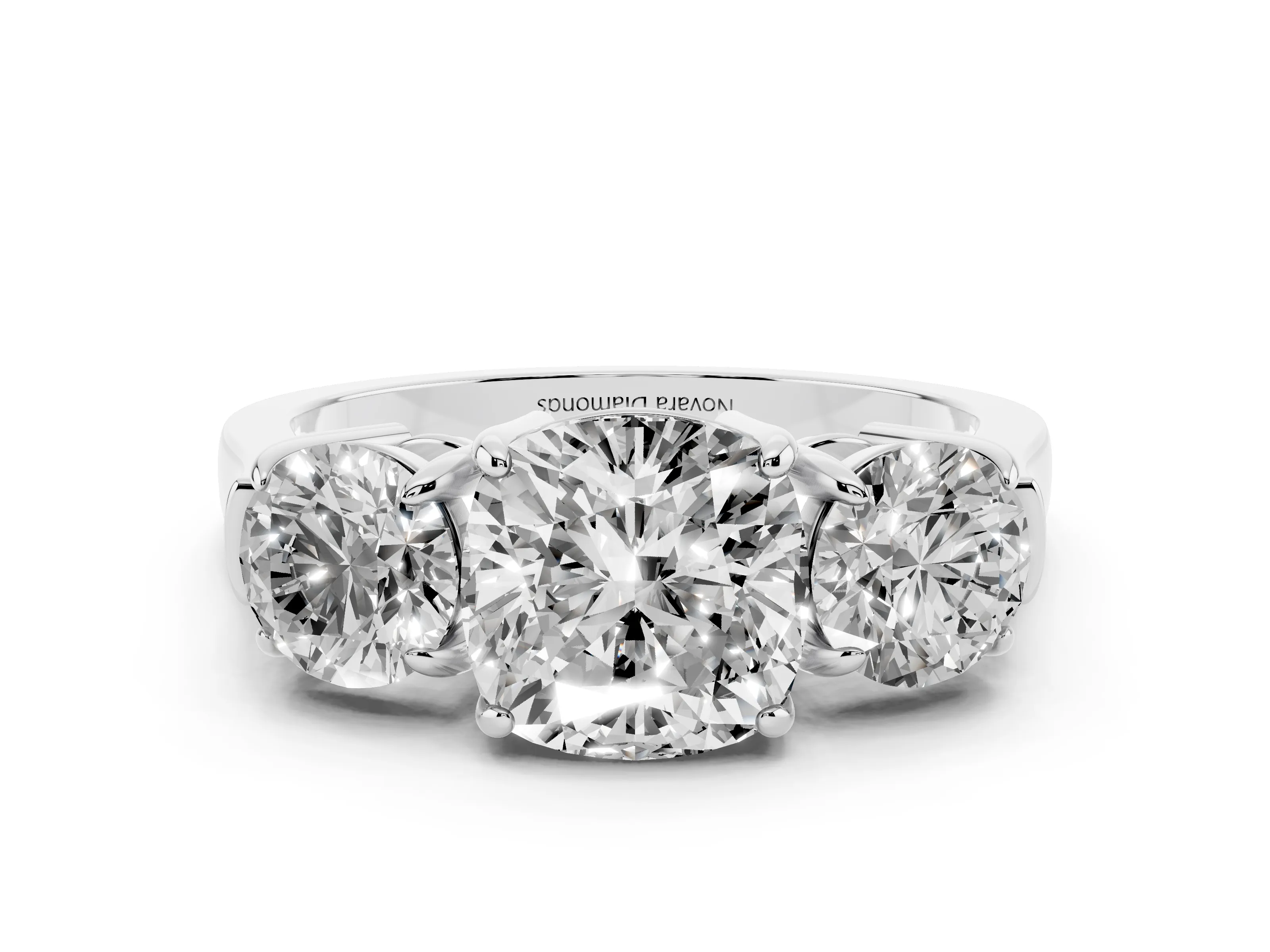 Cushion Cut Diamond Three-Stone Ring Set in Platinum with Round Accent Stones and Plain Band