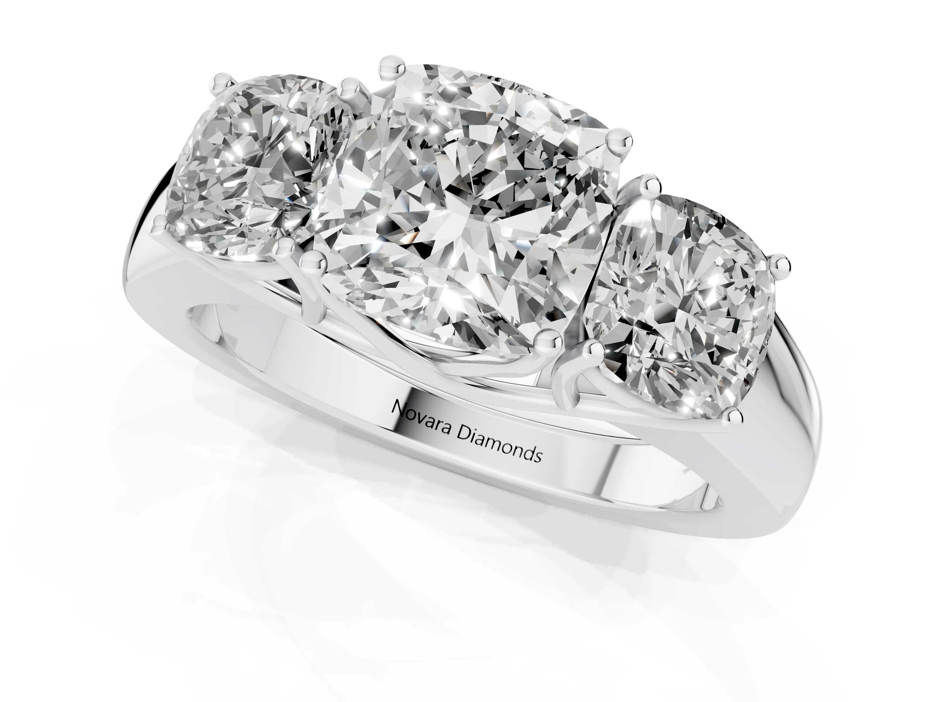 Three-Stone Cushion Cut Diamond Ring Set in Platinum with Matching Prong Settings and Plain Band