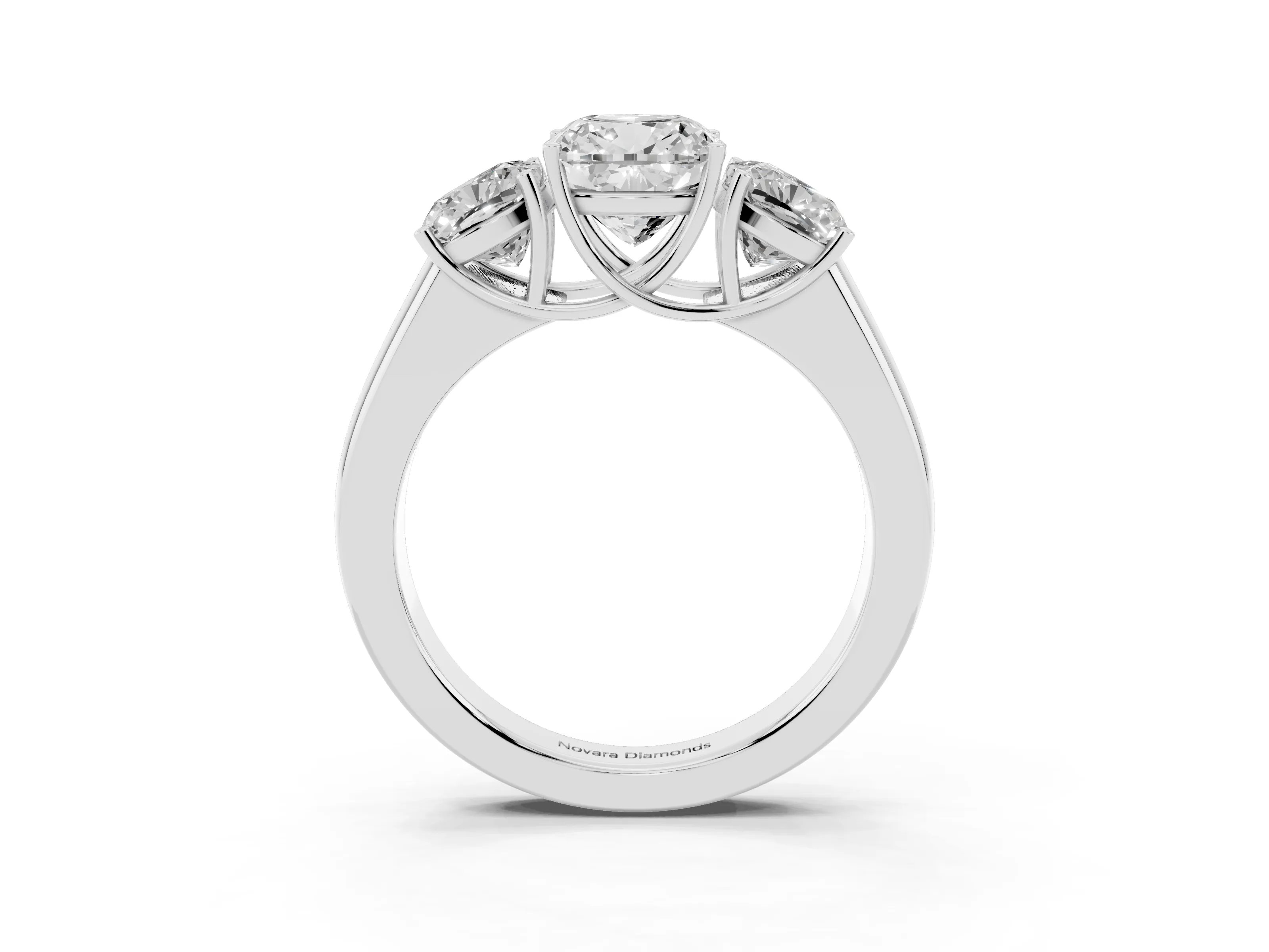 Three-Stone Cushion Cut Diamond Ring Set in Platinum with Matching Prong Settings and Plain Band