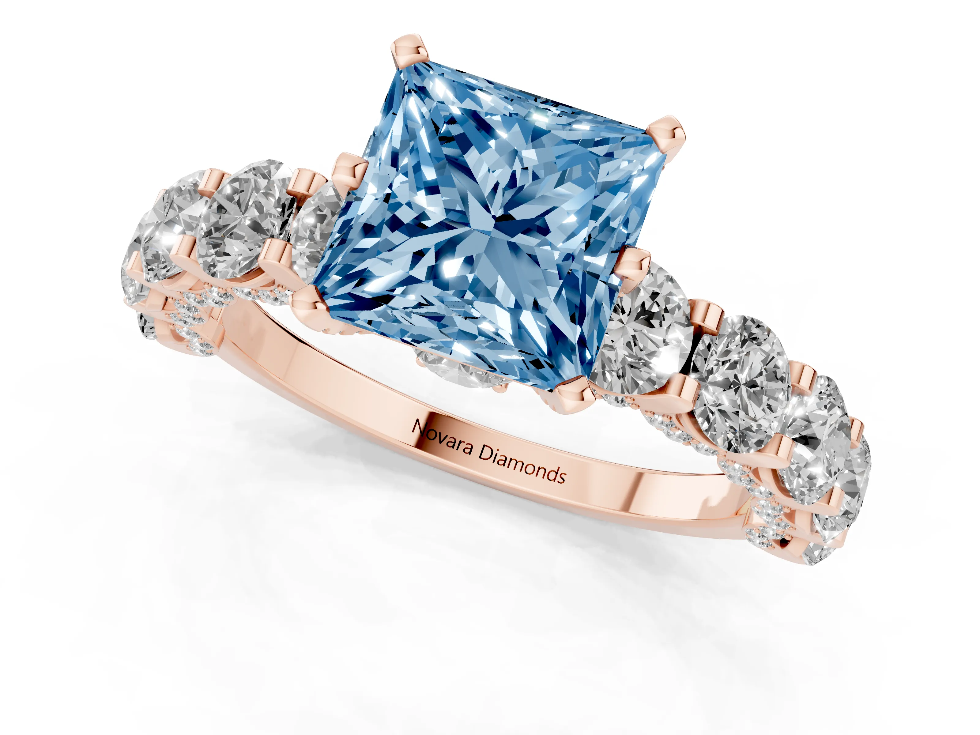 Fancy Blue Princess Cut Diamond Side Stone Ring Set in Rose gold with Alternating Round and Oval Side Stones