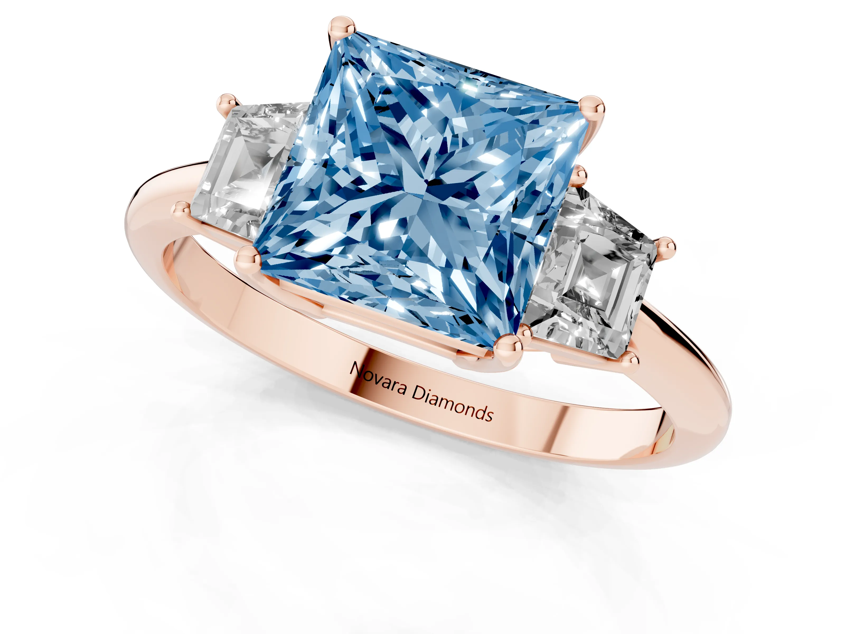 Fancy Blue Princess Cut Diamond Three-Stone Ring Set in Rose gold with Trapezoid Side Stones and Prong Setting