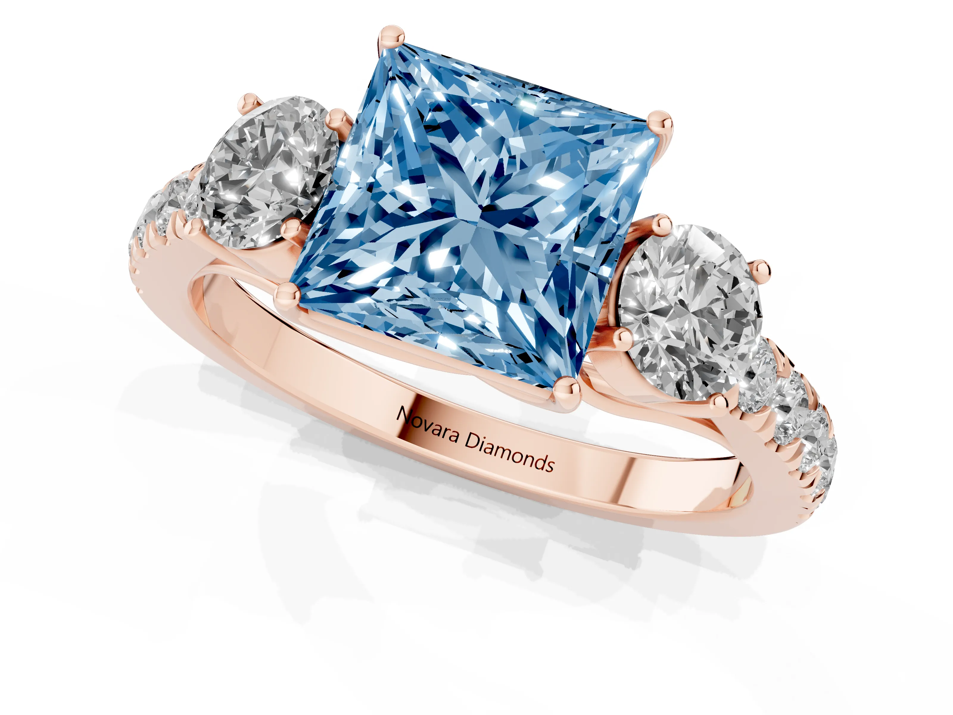 Fancy Blue Princess Cut Diamond Three-Stone Ring Set in Rose gold with Round Side Stones and Delicate Pavé Band