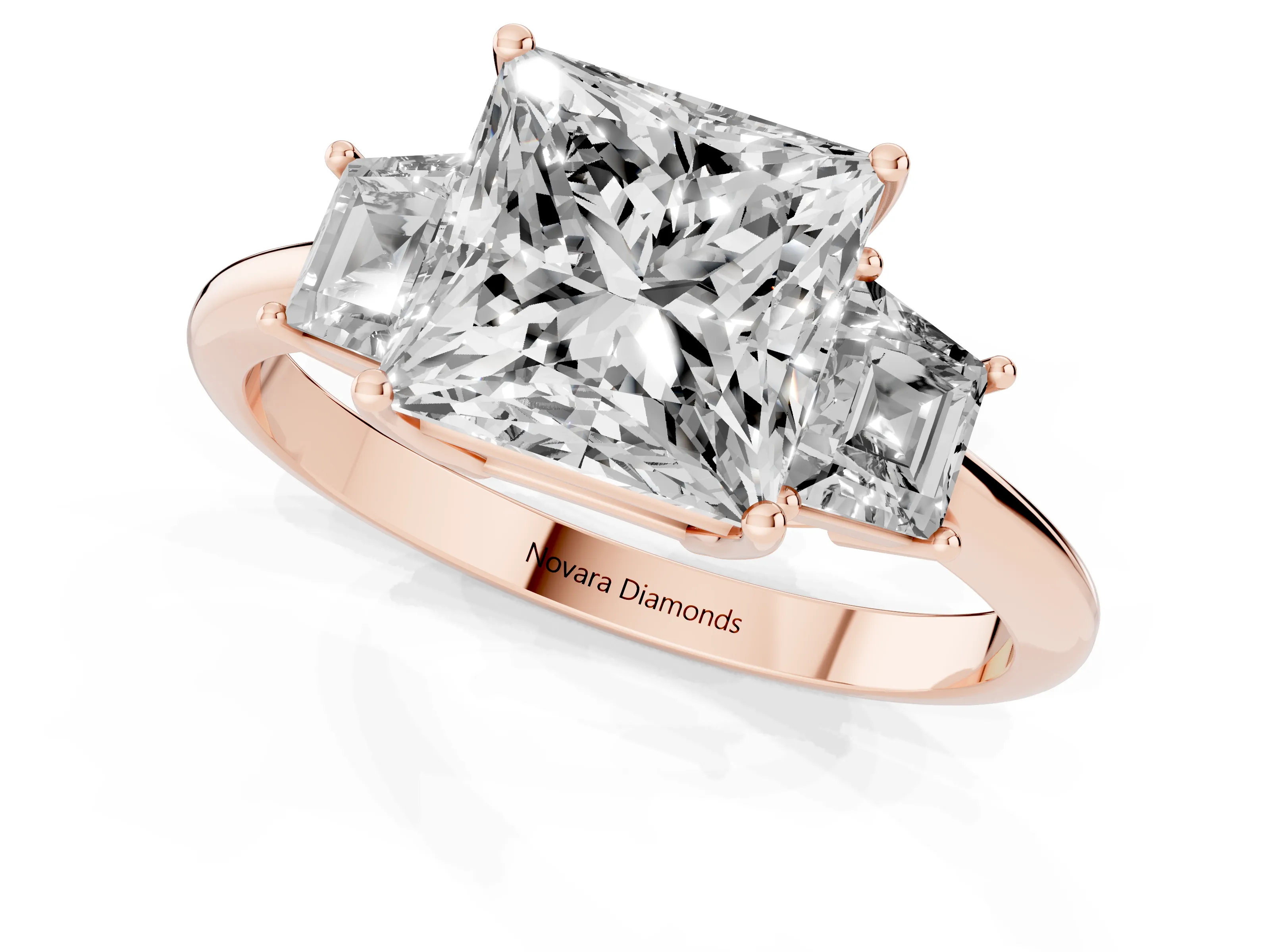 Princess Cut Diamond Three-Stone Ring Set in Rose gold with Trapezoid Side Stones and Prong Setting