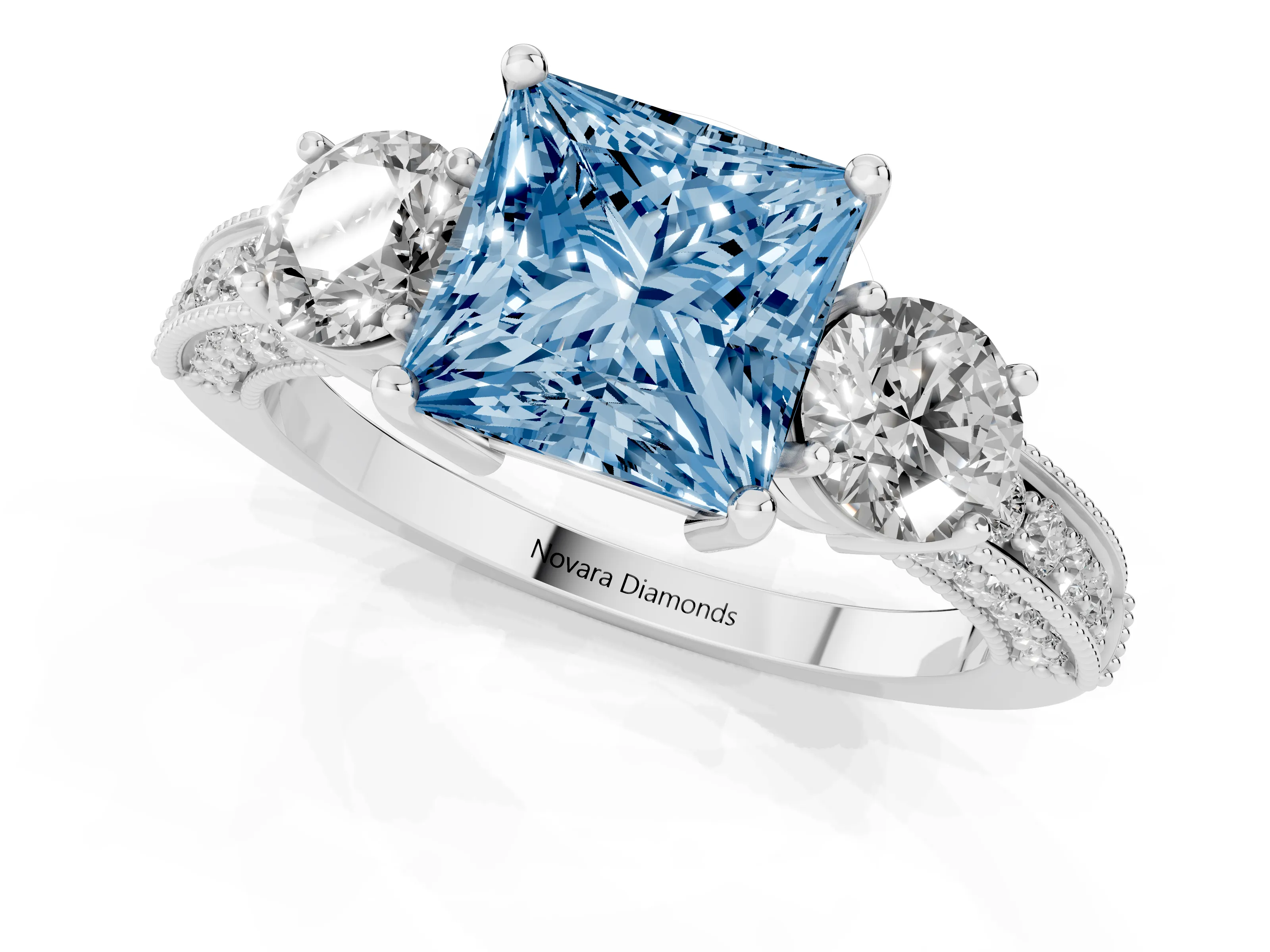 Fancy Blue Princess Cut Diamond Three-Stone Ring Set in White gold with Round Side Stones and Pavé Band
