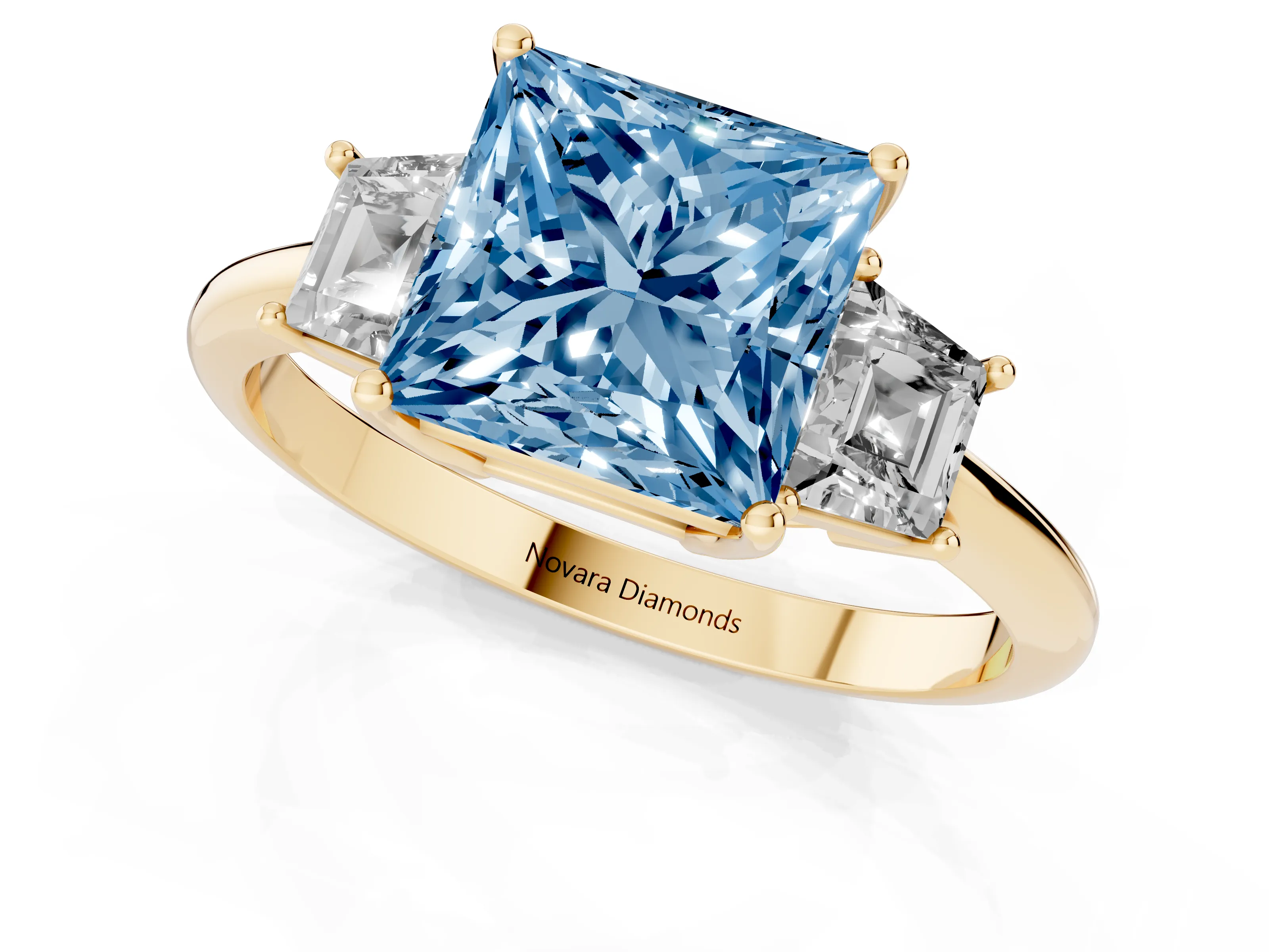 Fancy Blue Princess Cut Diamond Three-Stone Ring Set in Yellow gold with Trapezoid Side Stones and Prong Setting