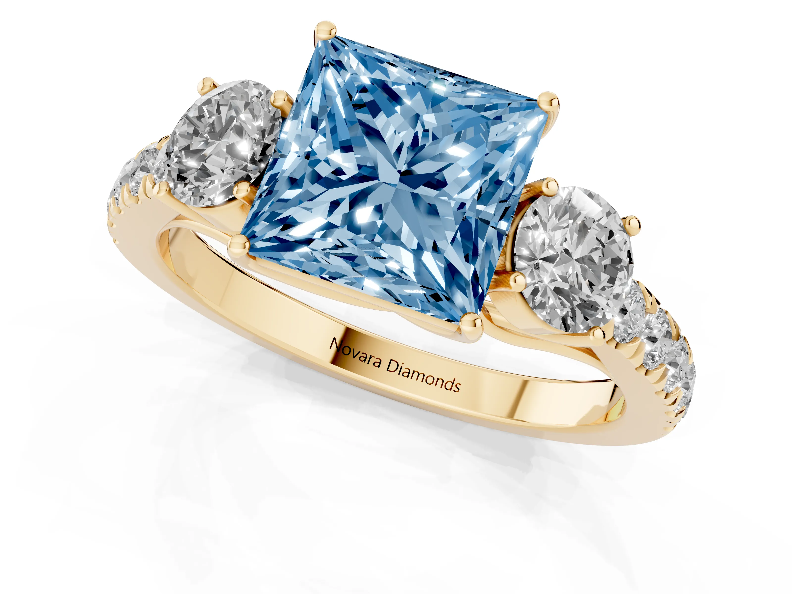 Fancy Blue Princess Cut Diamond Three-Stone Ring Set in Yellow gold with Round Side Stones and Delicate Pavé Band
