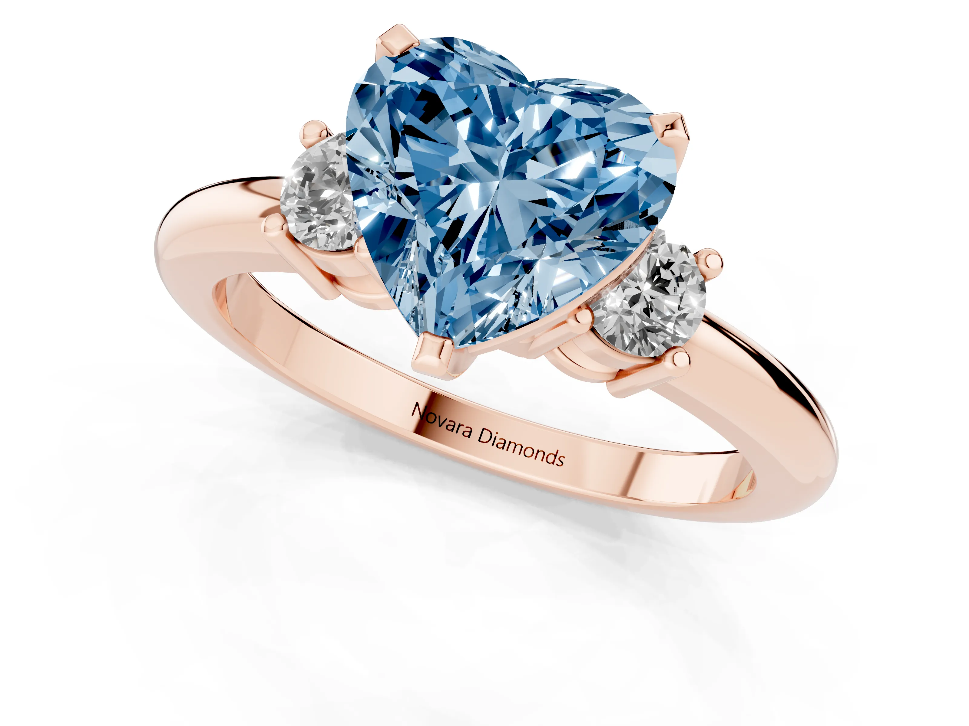 Fancy Blue Three-Stone Heart Cut Diamond Ring Set in Rose gold with Prong Setting and Plain Band