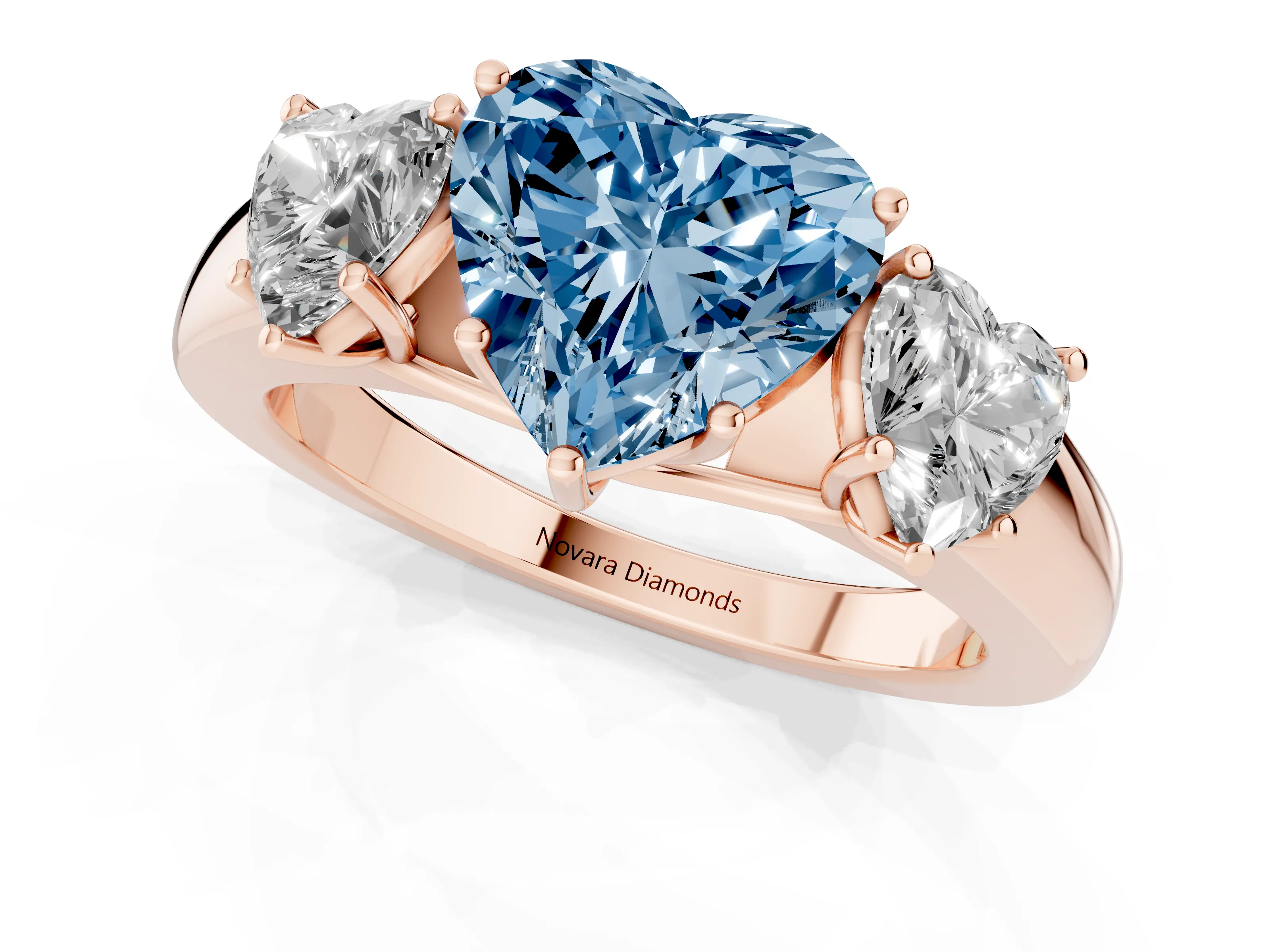 Fancy Blue Three-Stone Heart Cut Diamond Ring Set in Rose gold with Matching Prong Settings and Plain Band