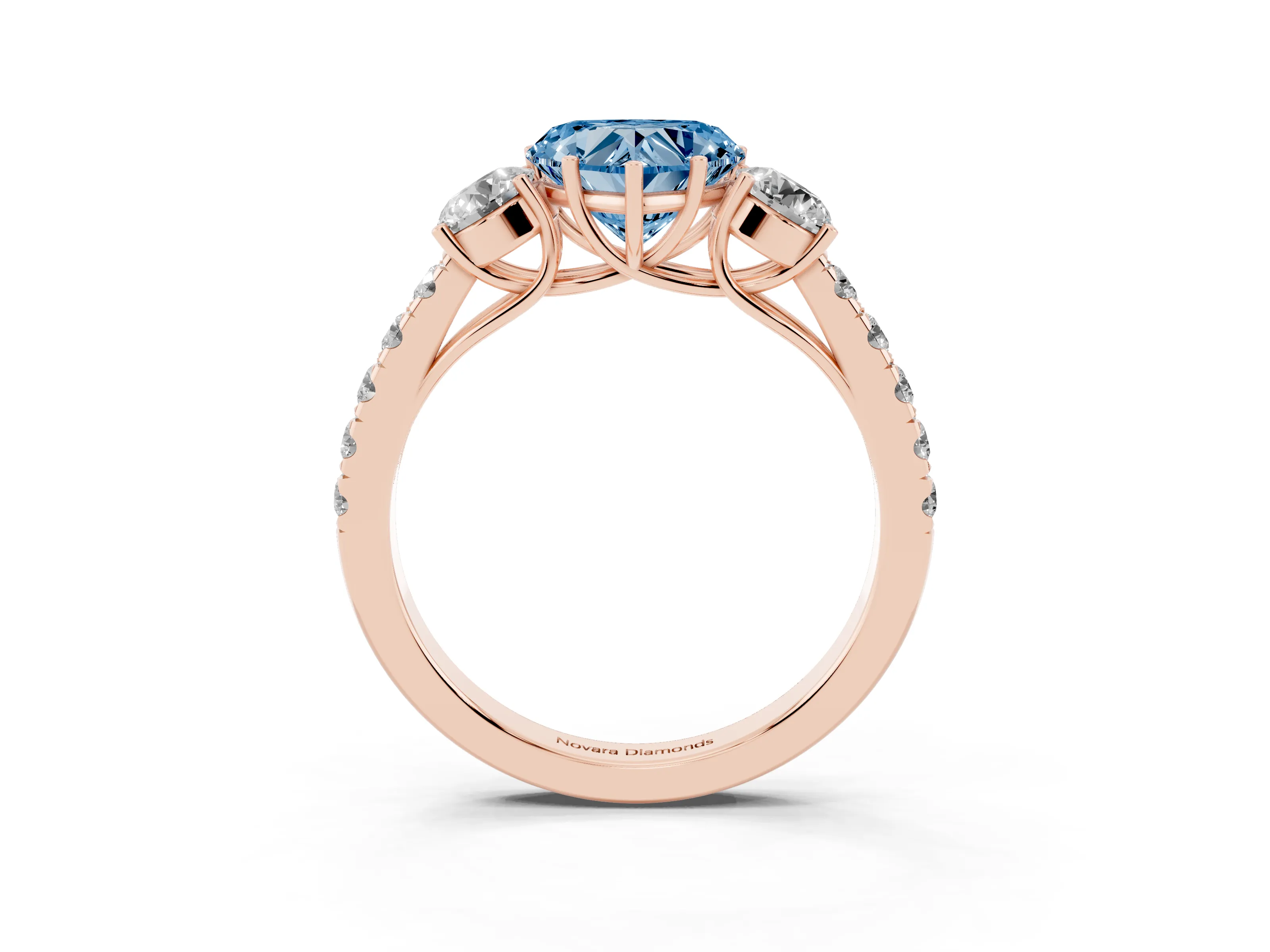 Fancy Blue Heart Cut Diamond Three-Stone Ring Set in Rose gold with Round Side Stones and Delicate Pavé Band