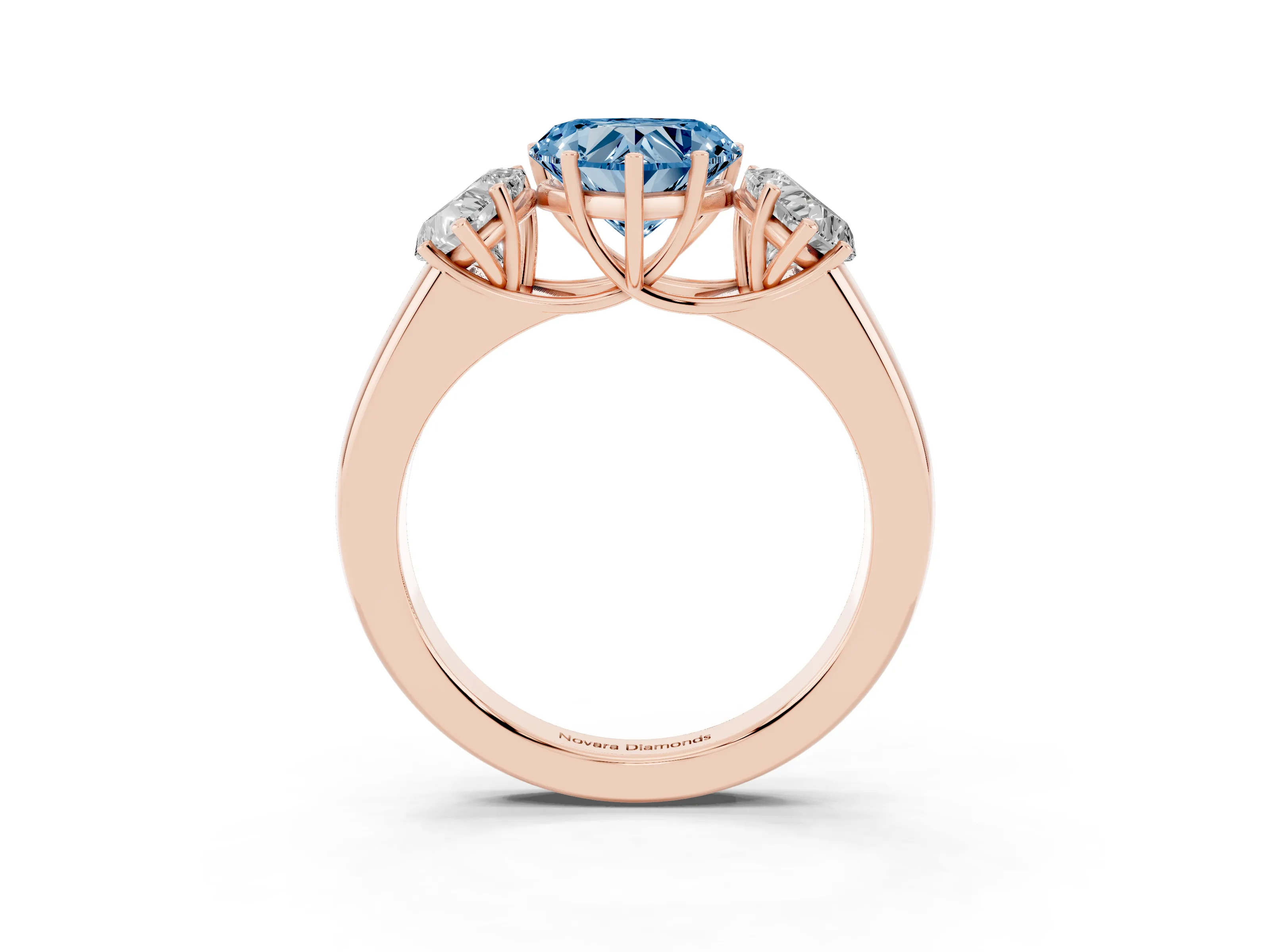 Fancy Blue Three-Stone Heart Cut Diamond Ring Set in Rose gold with Matching Prong Settings and Plain Band