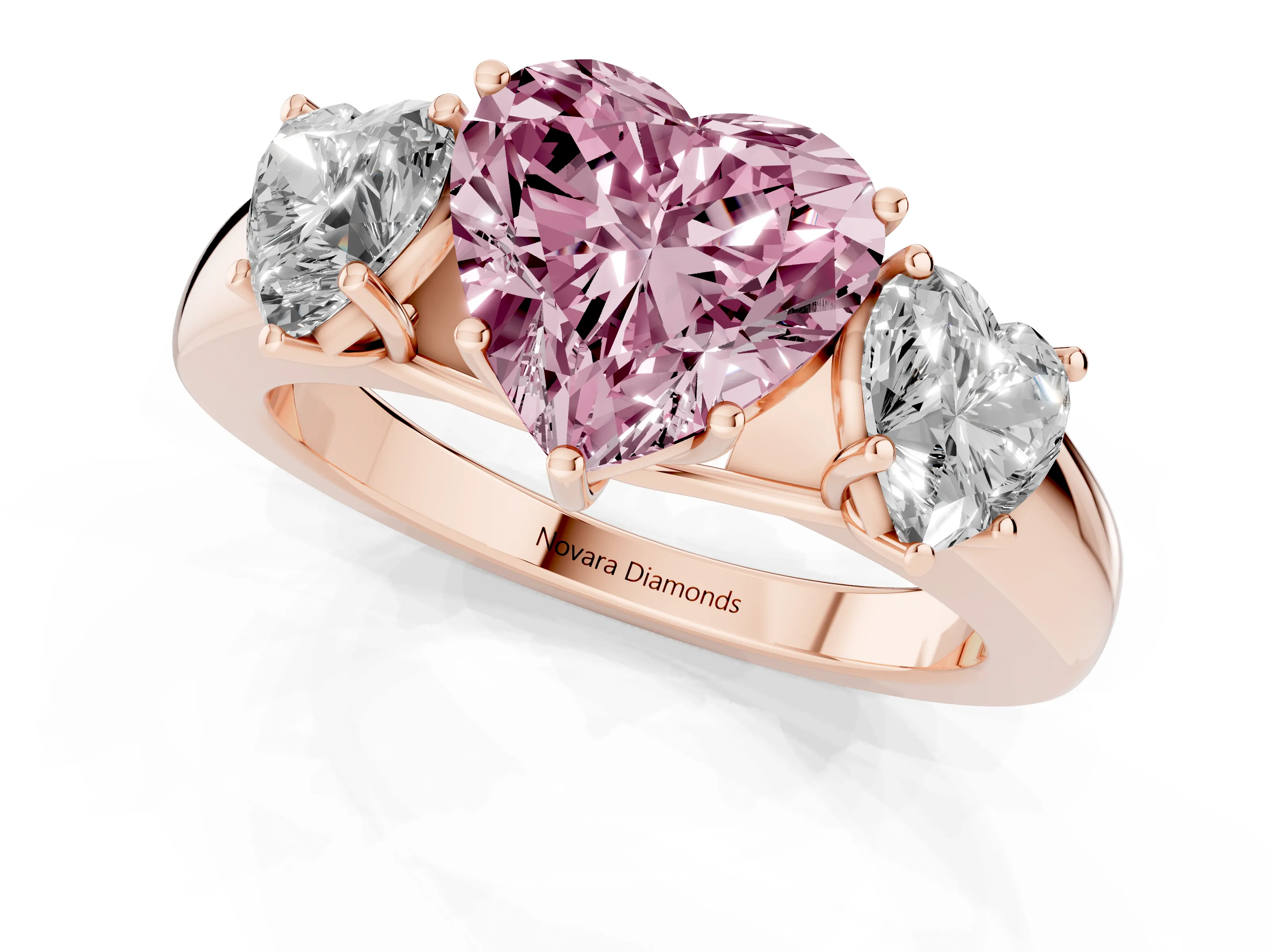 Fancy Pink Three-Stone Heart Cut Diamond Ring Set in Rose gold with Matching Prong Settings and Plain Band