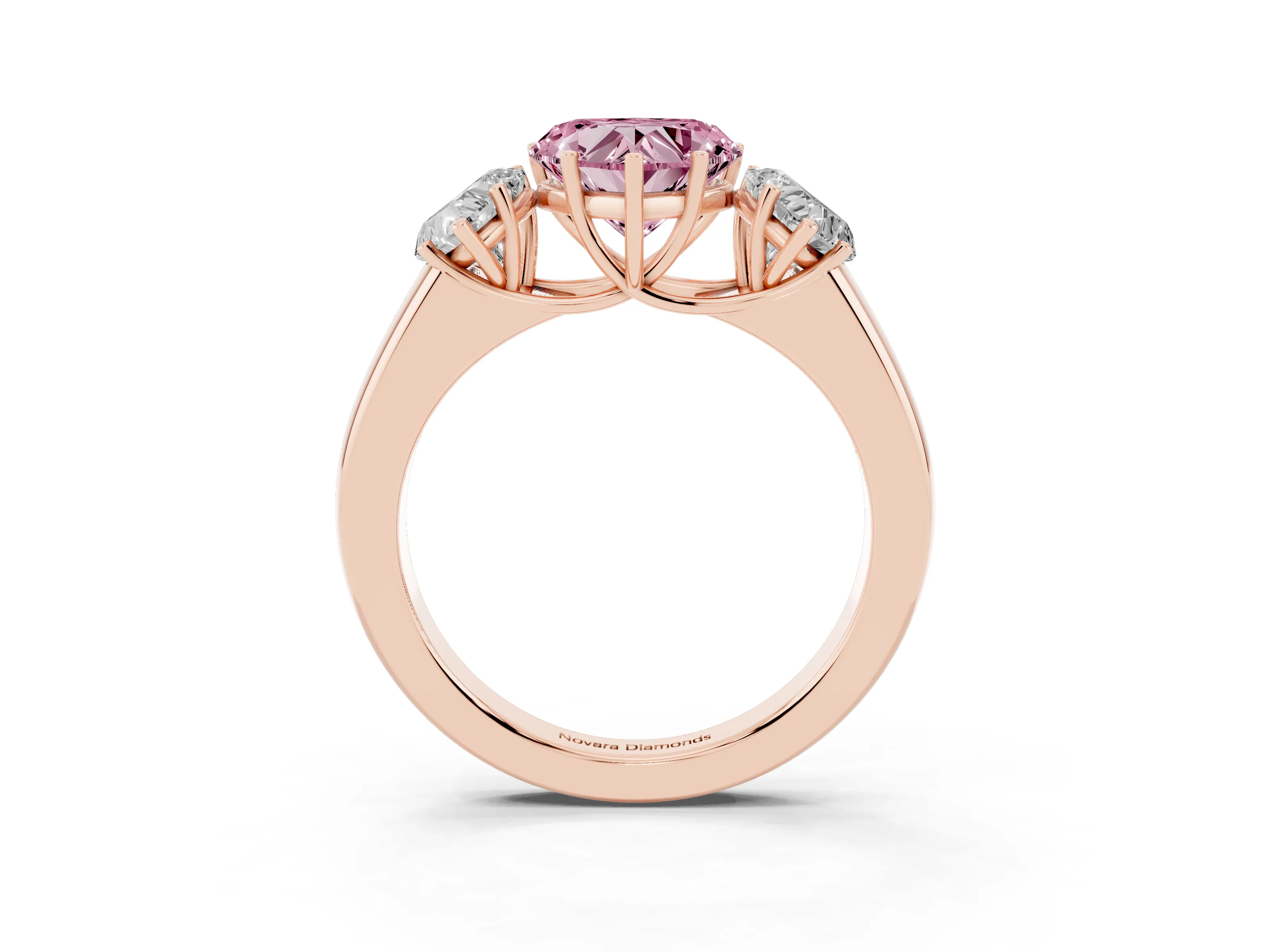 Fancy Pink Three-Stone Heart Cut Diamond Ring Set in Rose gold with Matching Prong Settings and Plain Band