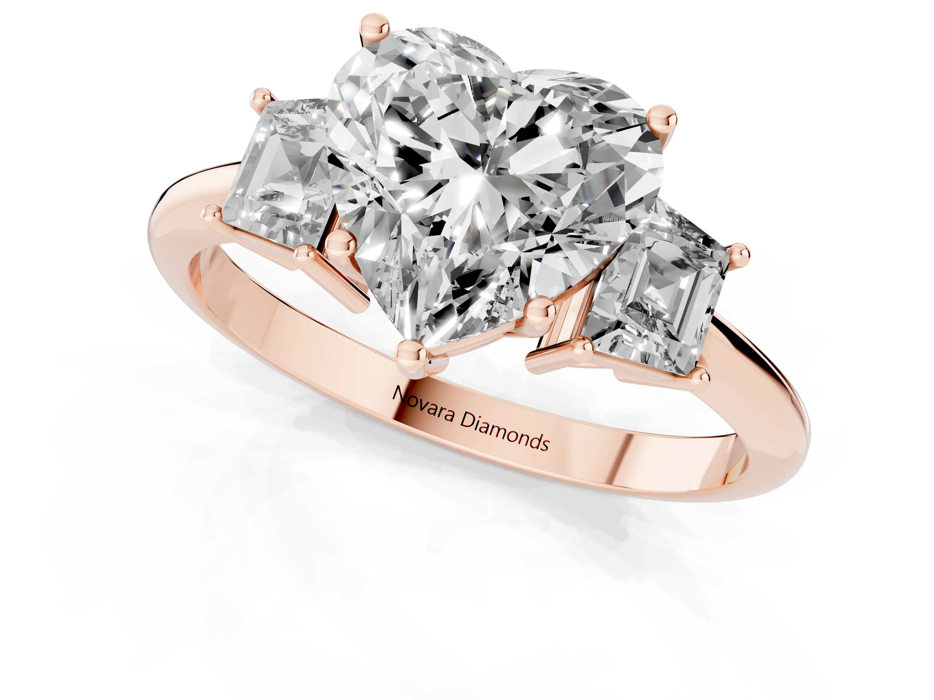 Heart Cut Diamond Three-Stone Ring Set in Rose gold with Trapezoid Side Stones and Prong Setting