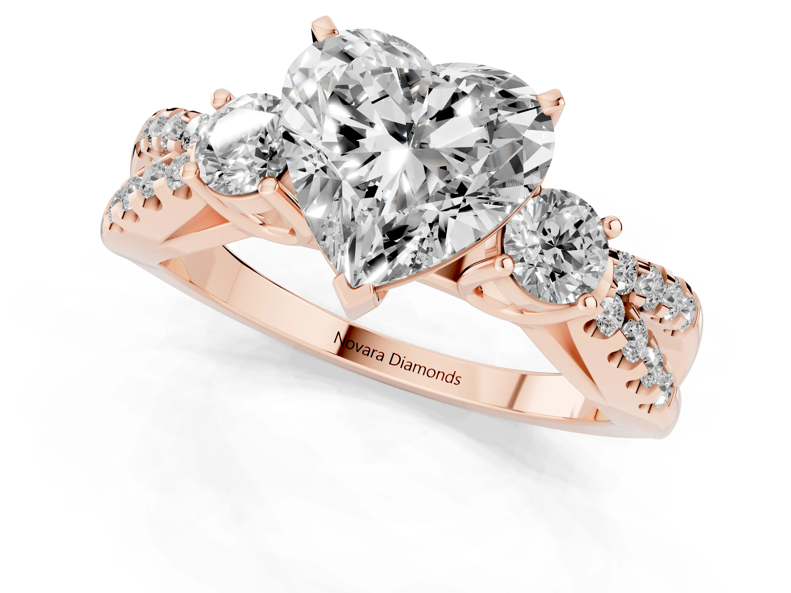 Heart Cut Diamond Three-Stone Ring Set in Rose gold with Pavé Split Shank and Prong Setting