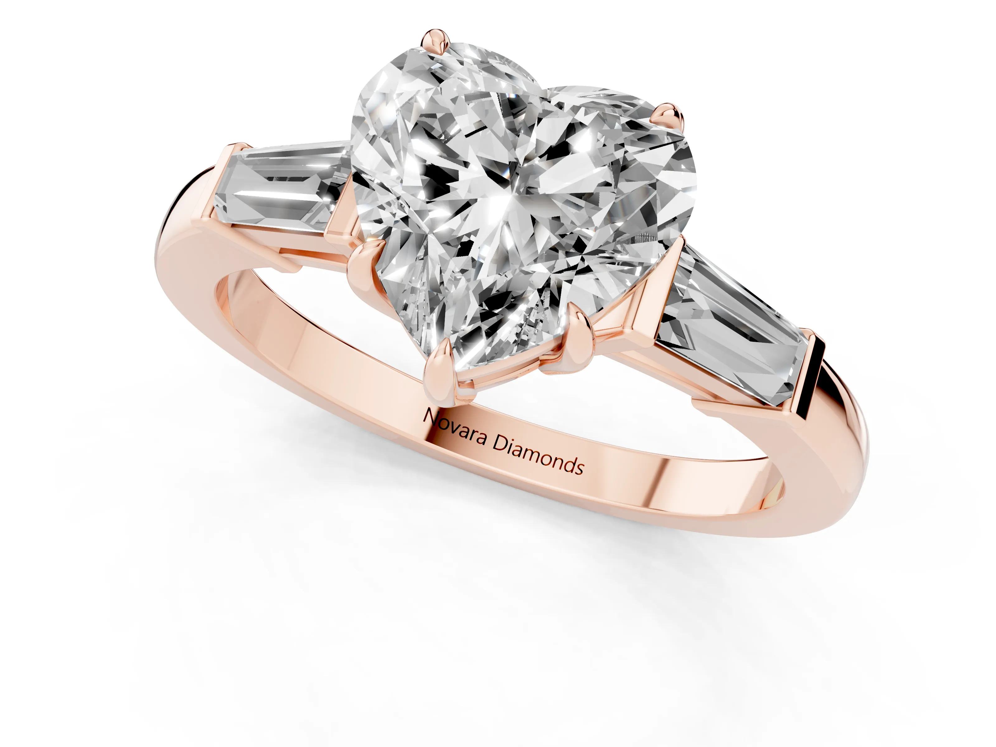 Heart Cut Diamond Three-Stone Ring Set in Rose gold with Tapered Baguette Side Stones and Prong Setting