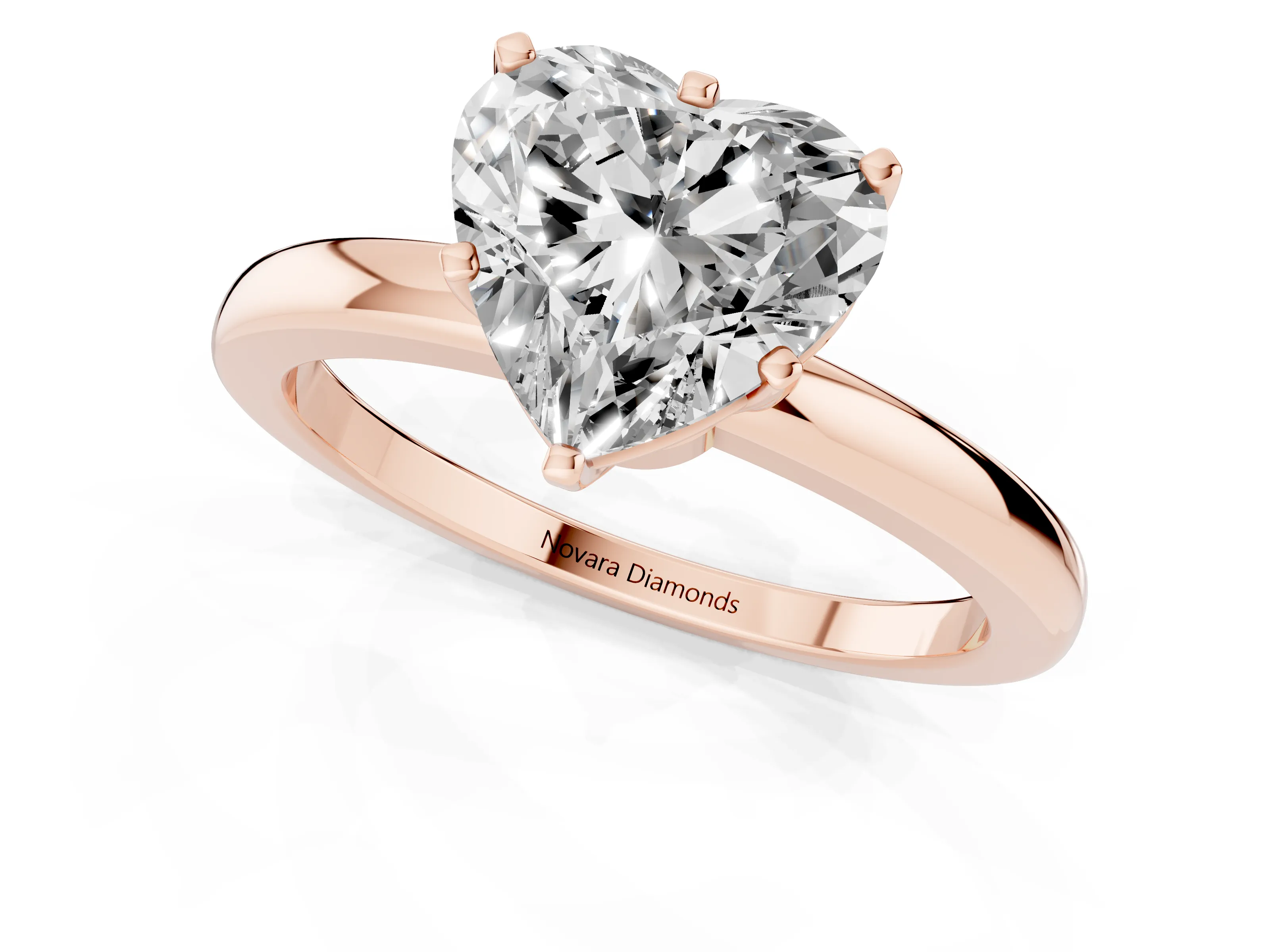 Heart Cut Diamond Solitaire Ring Set in Rose gold with Raised Prong Setting on a Classic Band