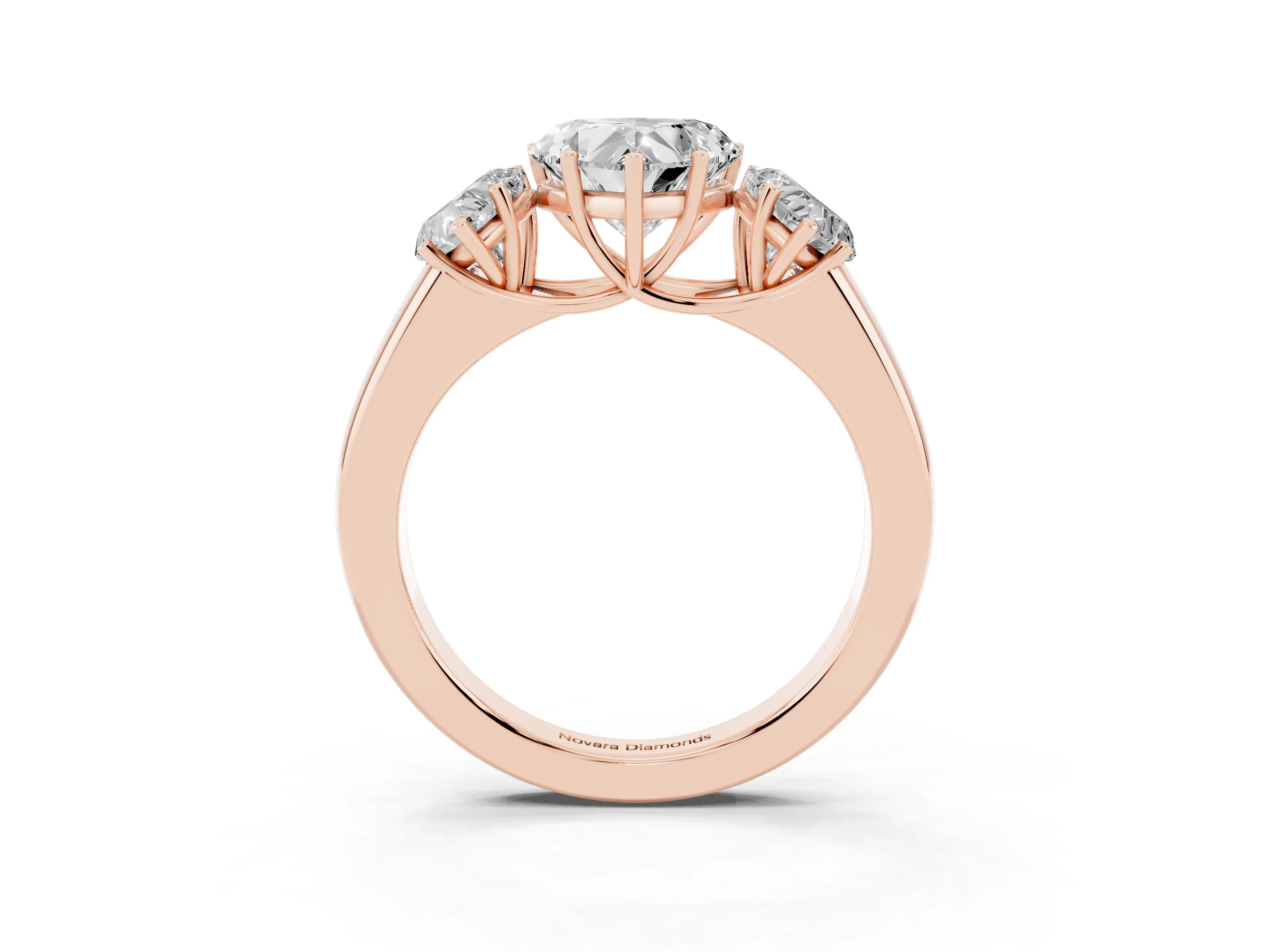 Three-Stone Heart Cut Diamond Ring Set in Rose gold with Matching Prong Settings and Plain Band
