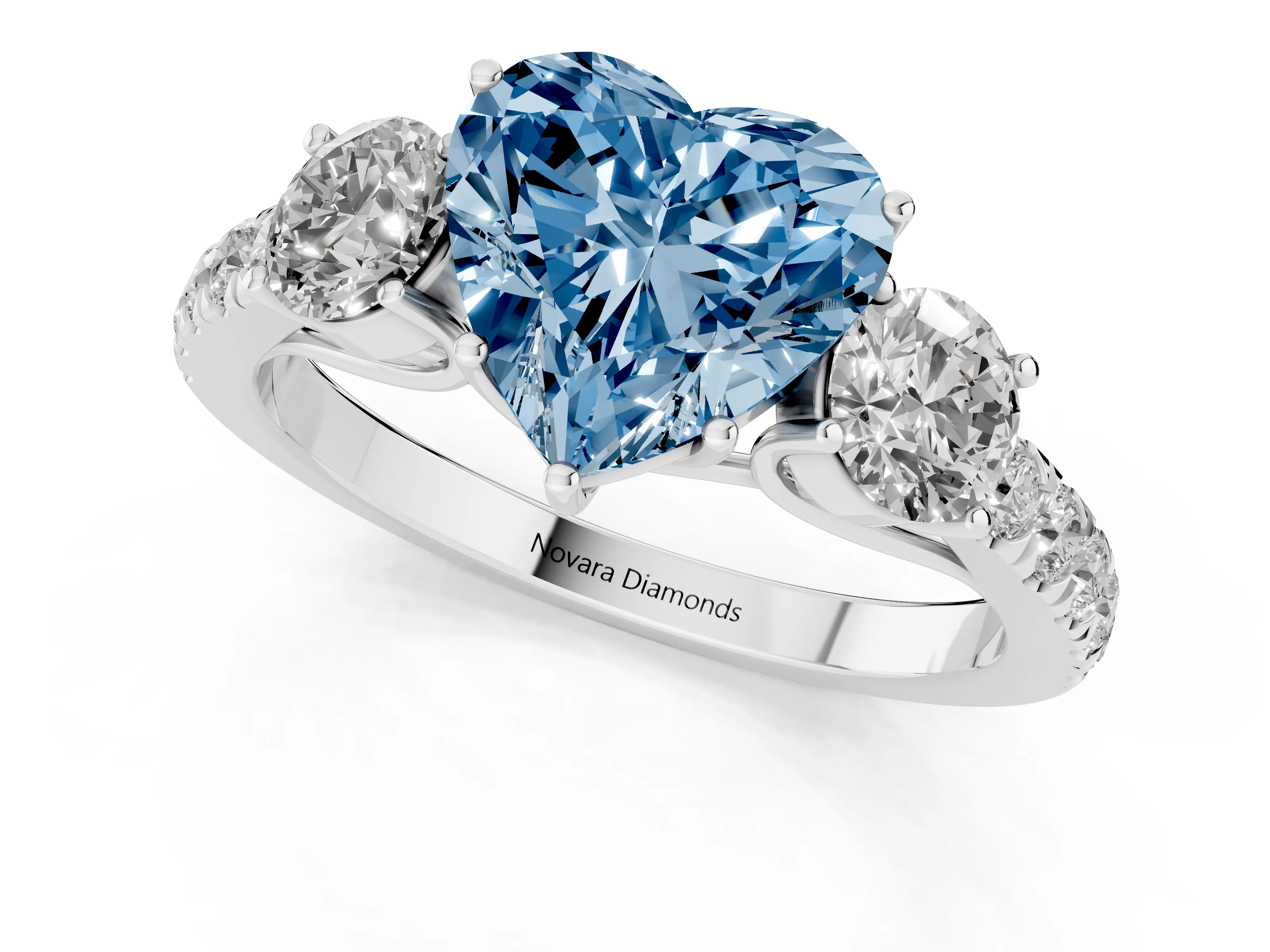 Fancy Blue Heart Cut Diamond Three-Stone Ring Set in White gold with Round Side Stones and Delicate Pavé Band