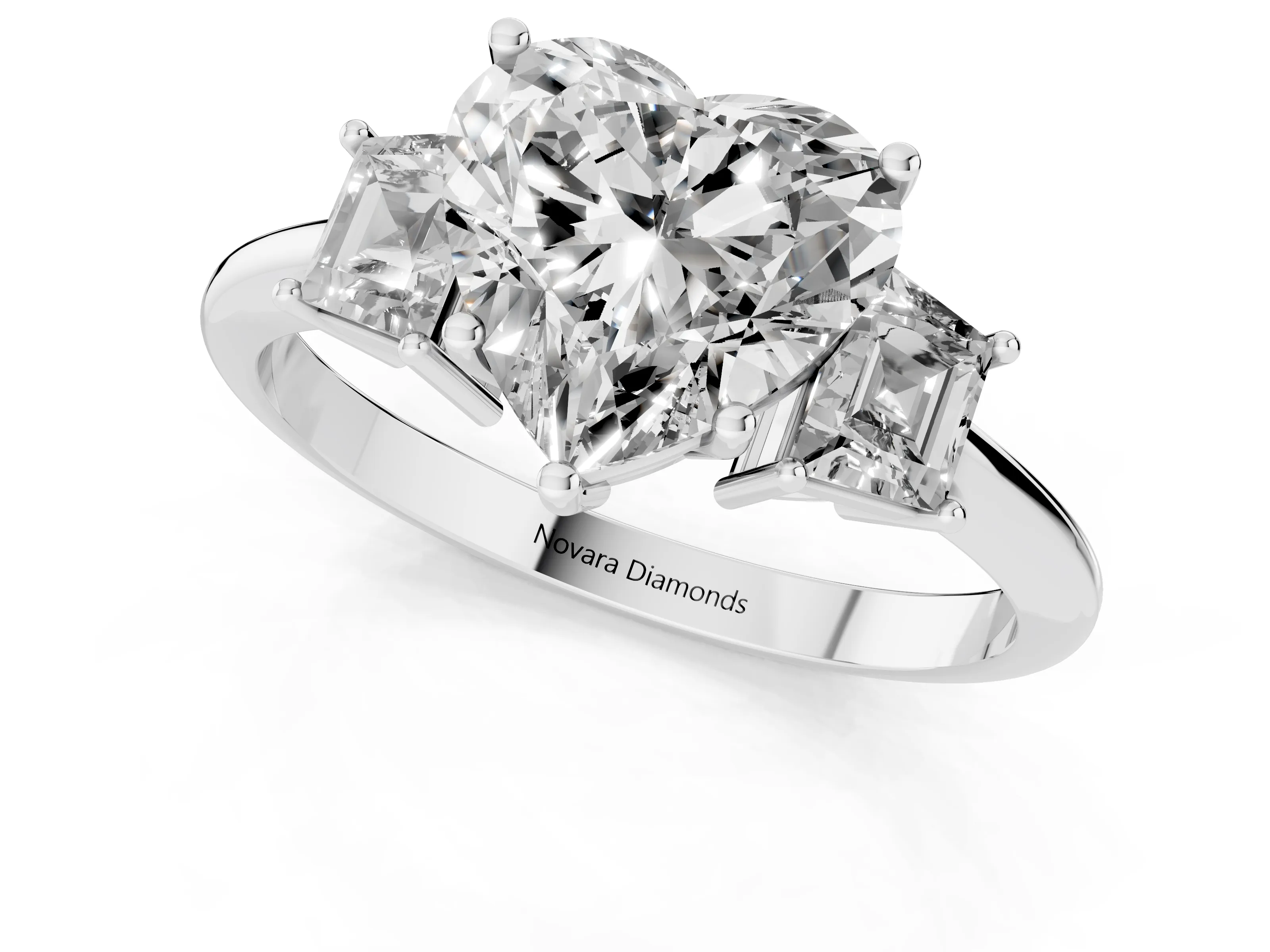 Heart Cut Diamond Three-Stone Ring Set in Platinum with Trapezoid Side Stones and Prong Setting