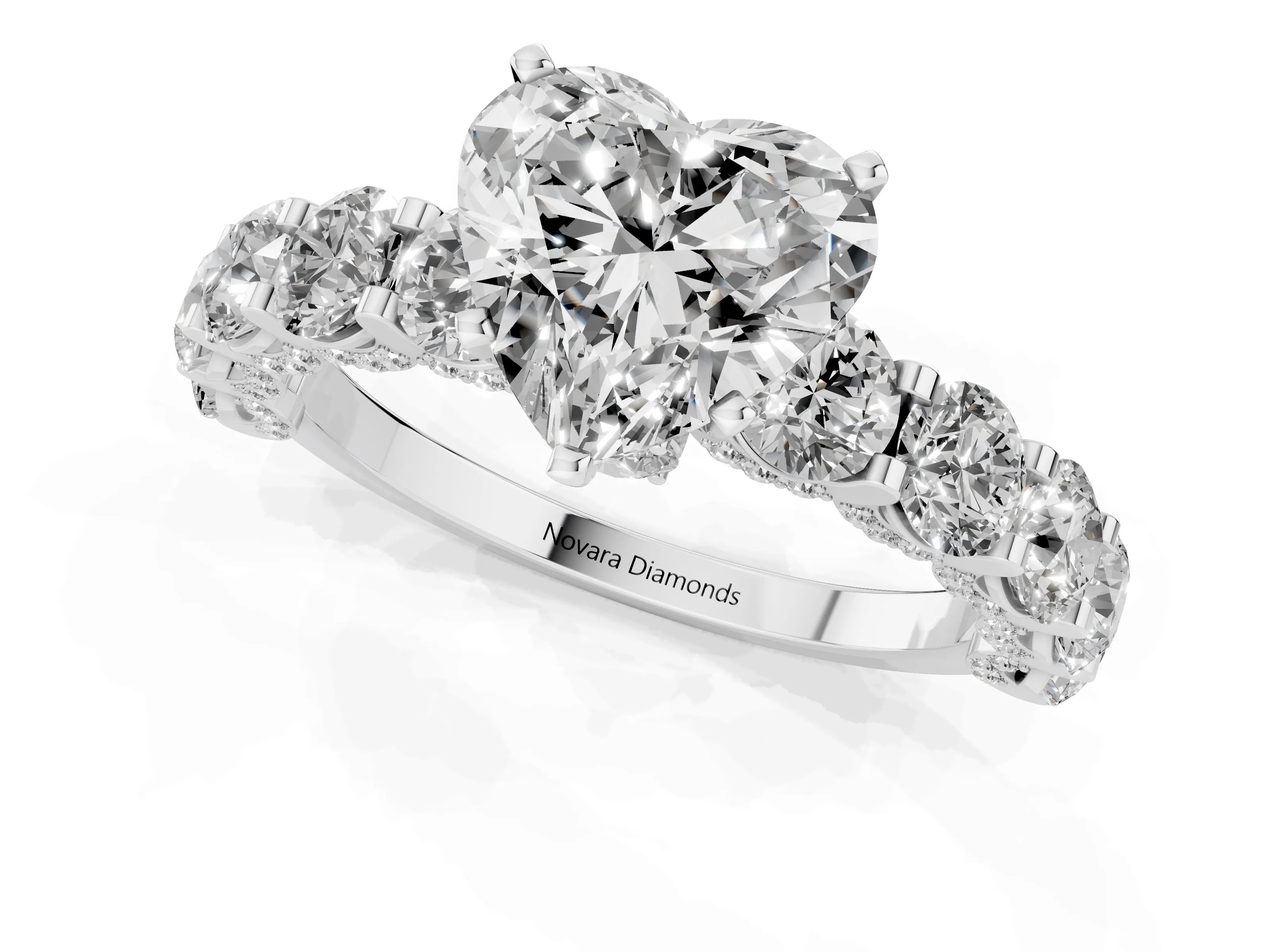 Heart Cut Diamond Side Stone Ring Set in Platinum with Alternating Round and Oval Side Stones