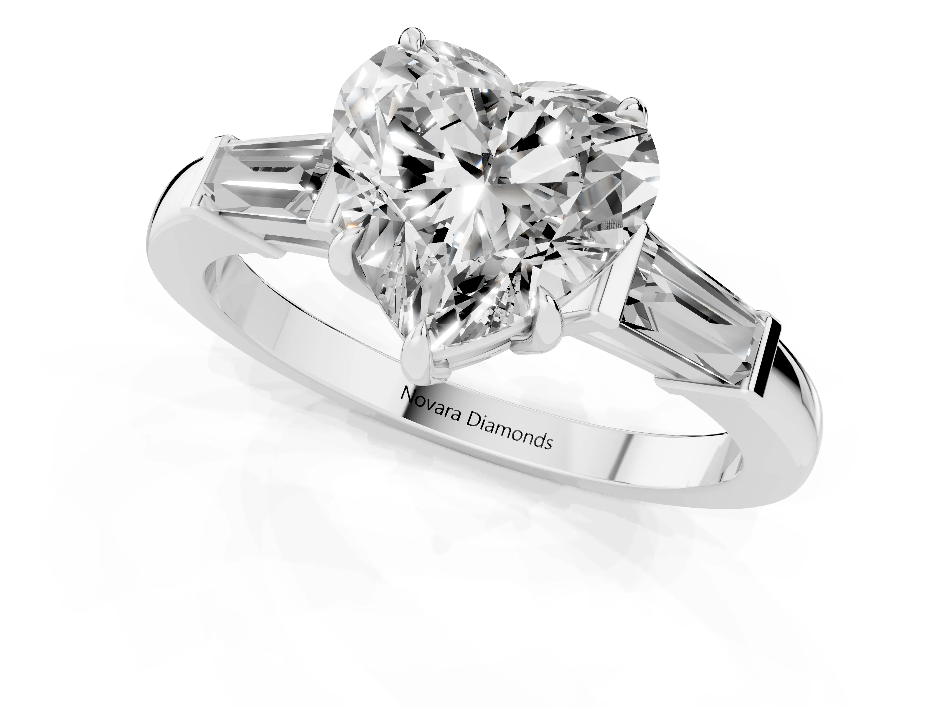 Heart Cut Diamond Three-Stone Ring Set in Platinum with Tapered Baguette Side Stones and Prong Setting