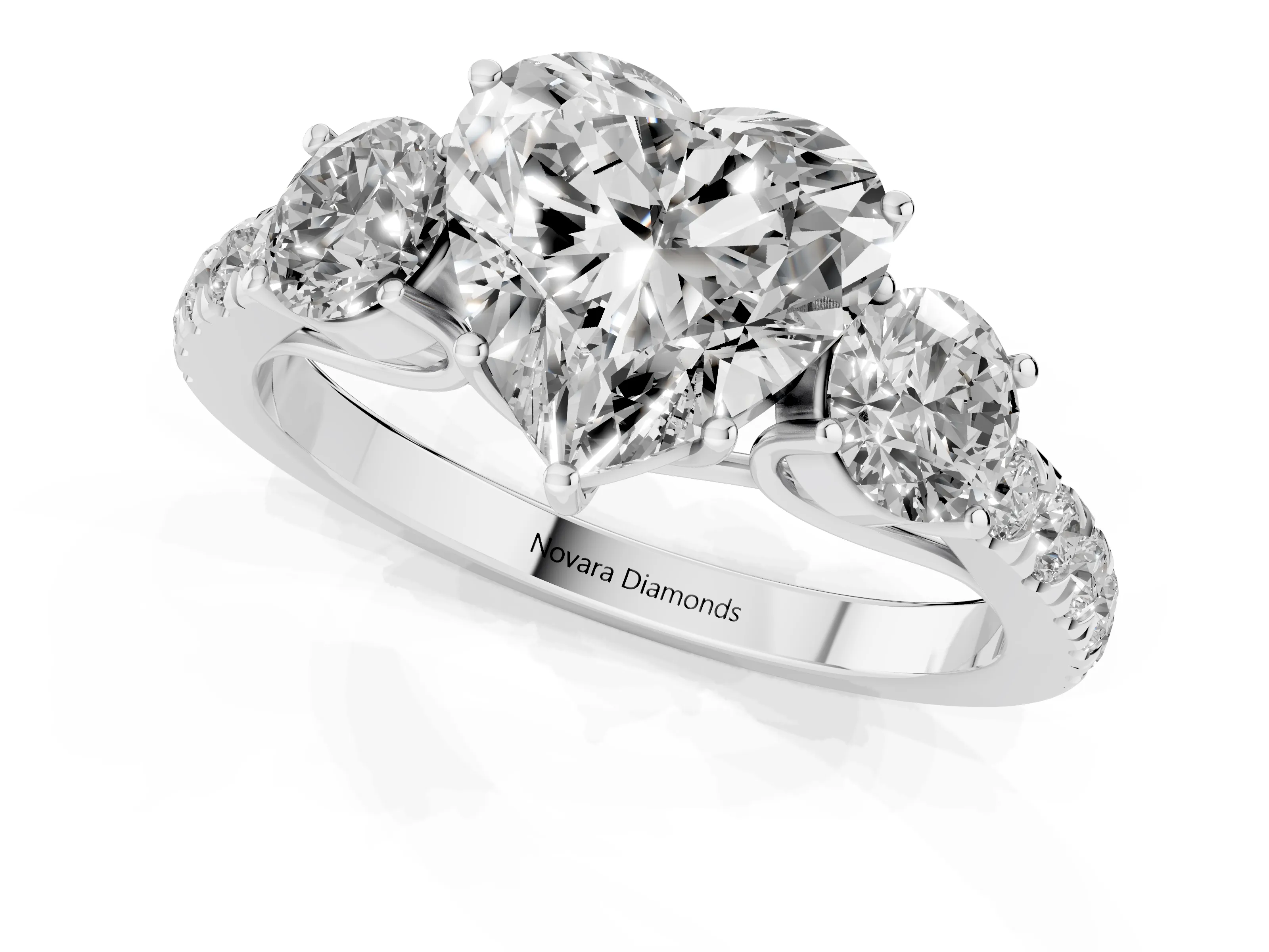 Heart Cut Diamond Three-Stone Ring Set in White gold with Round Side Stones and Delicate Pavé Band
