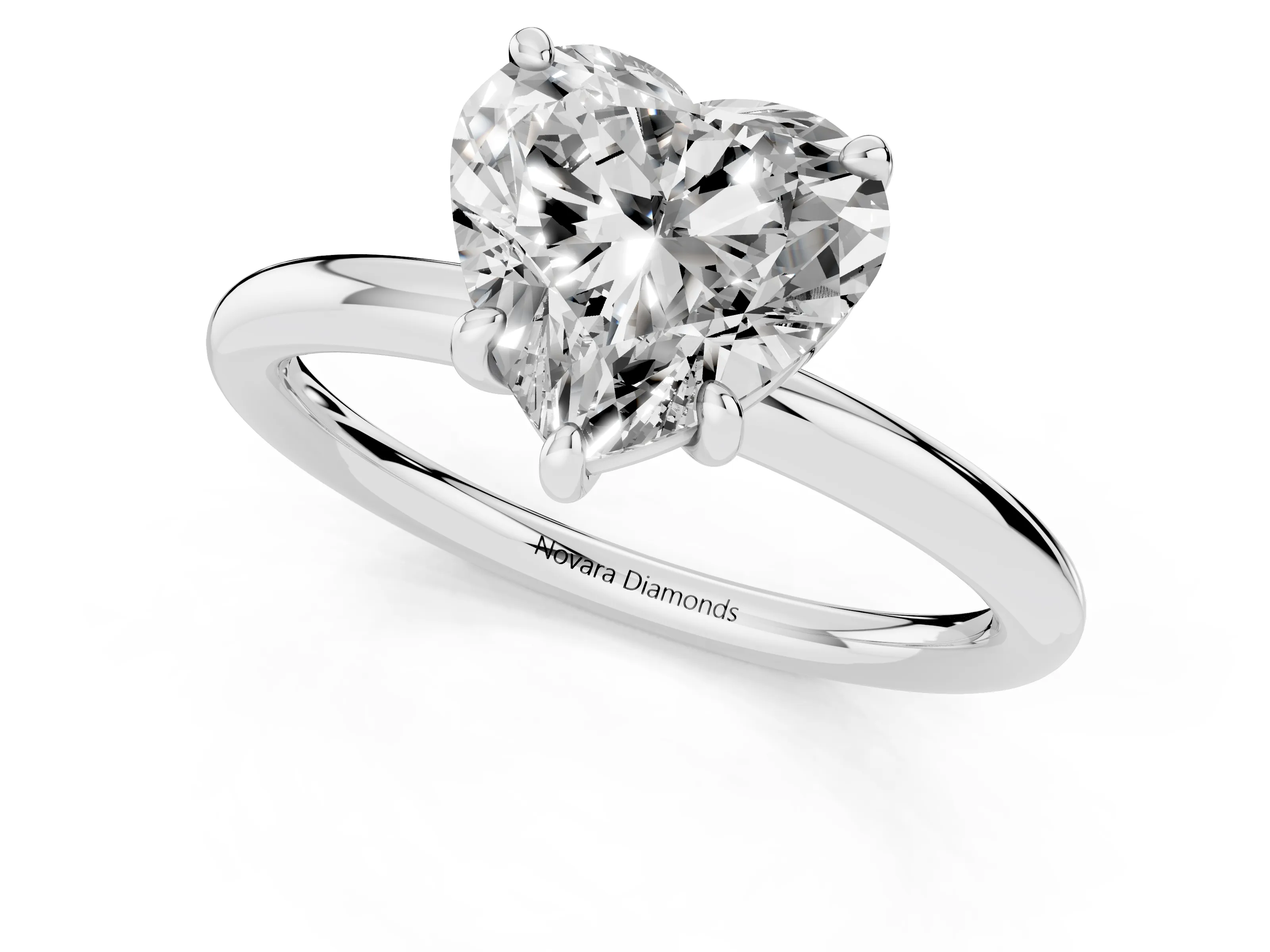 Heart Cut Diamond Solitaire Ring Set in Platinum with Prong Setting on a Polished Plain Band