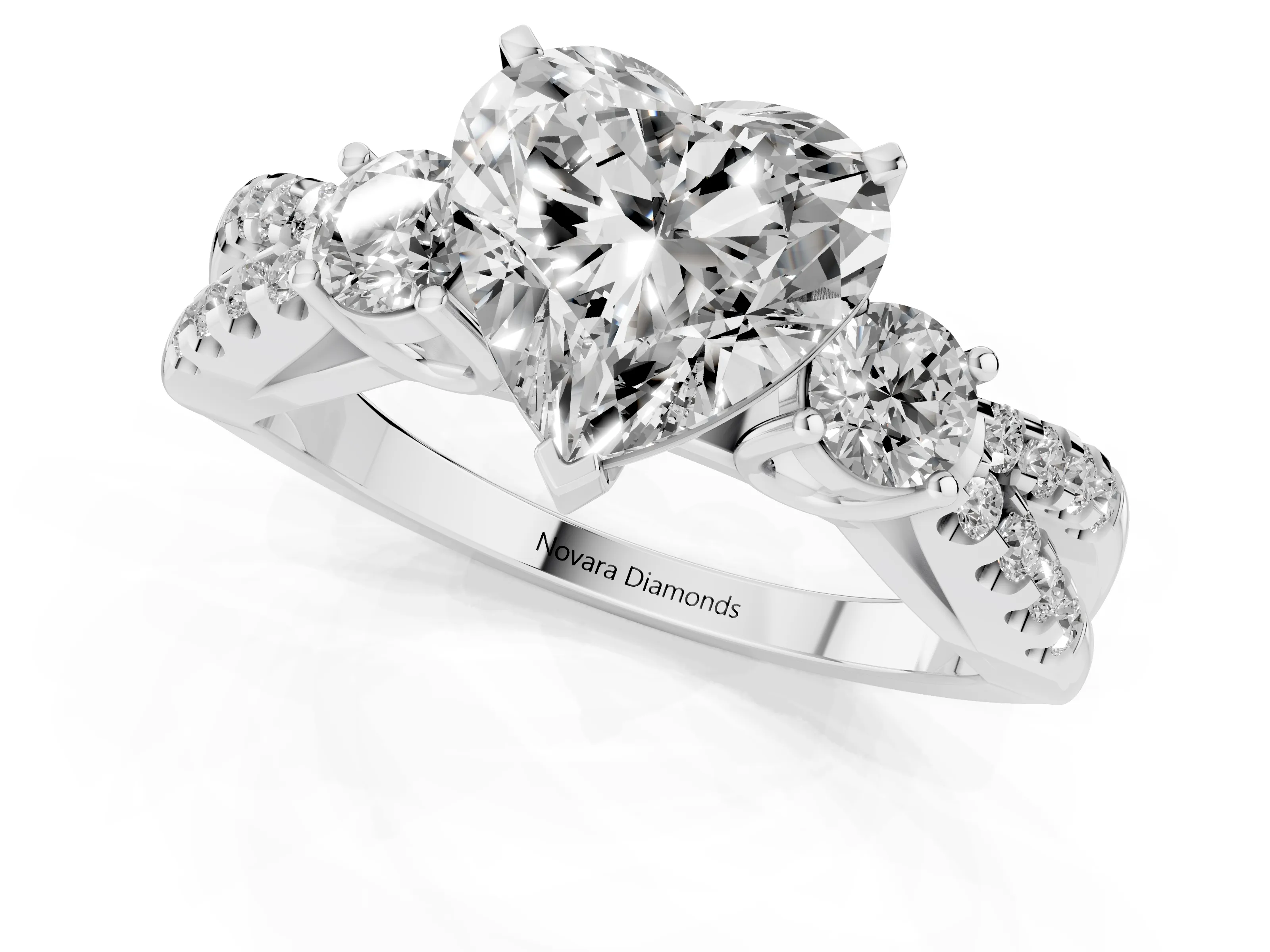 Heart Cut Diamond Three-Stone Ring Set in Platinum with Pavé Split Shank and Prong Setting