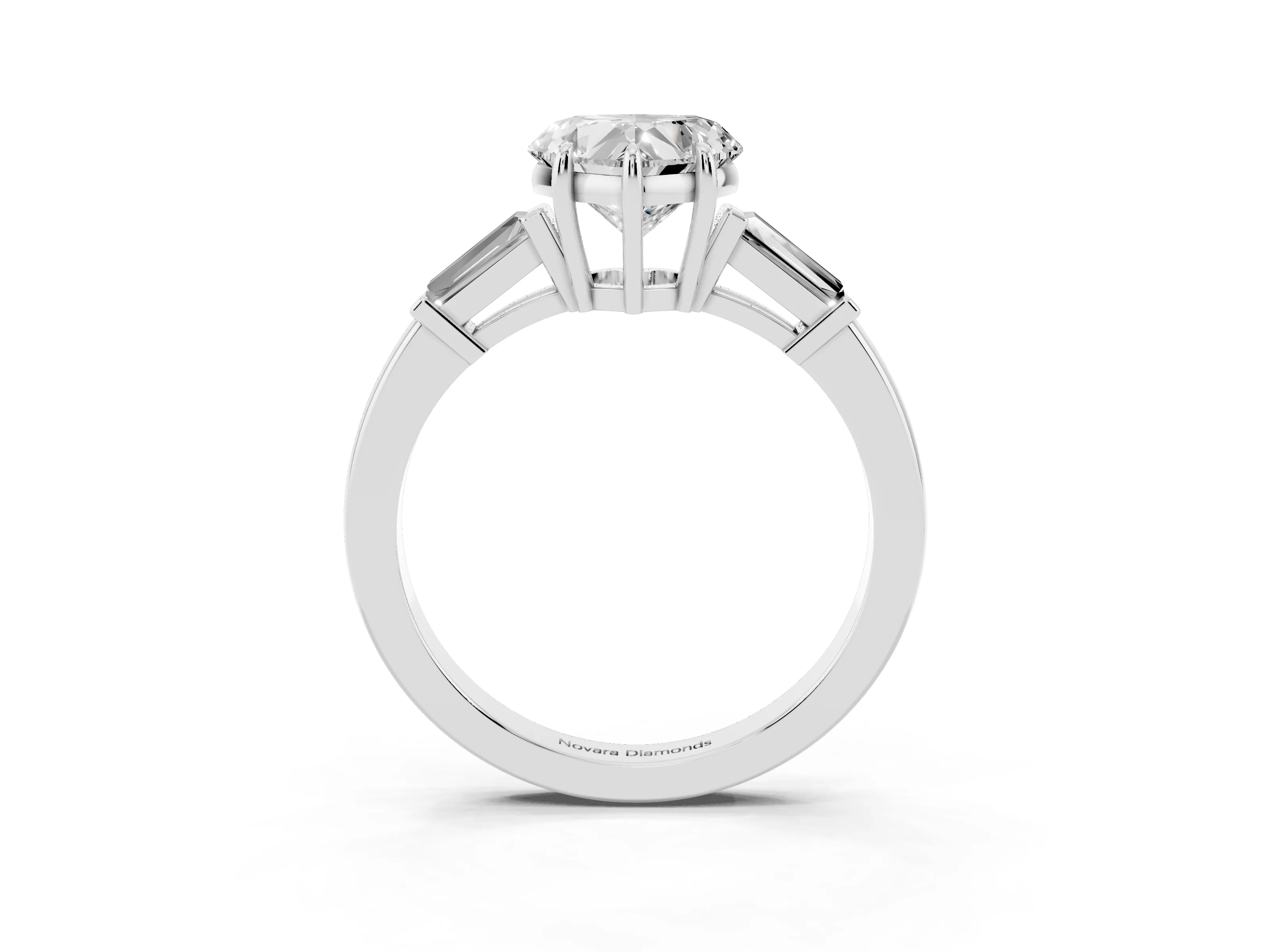 Heart Cut Diamond Three-Stone Ring Set in Platinum with Tapered Baguette Side Stones and Prong Setting